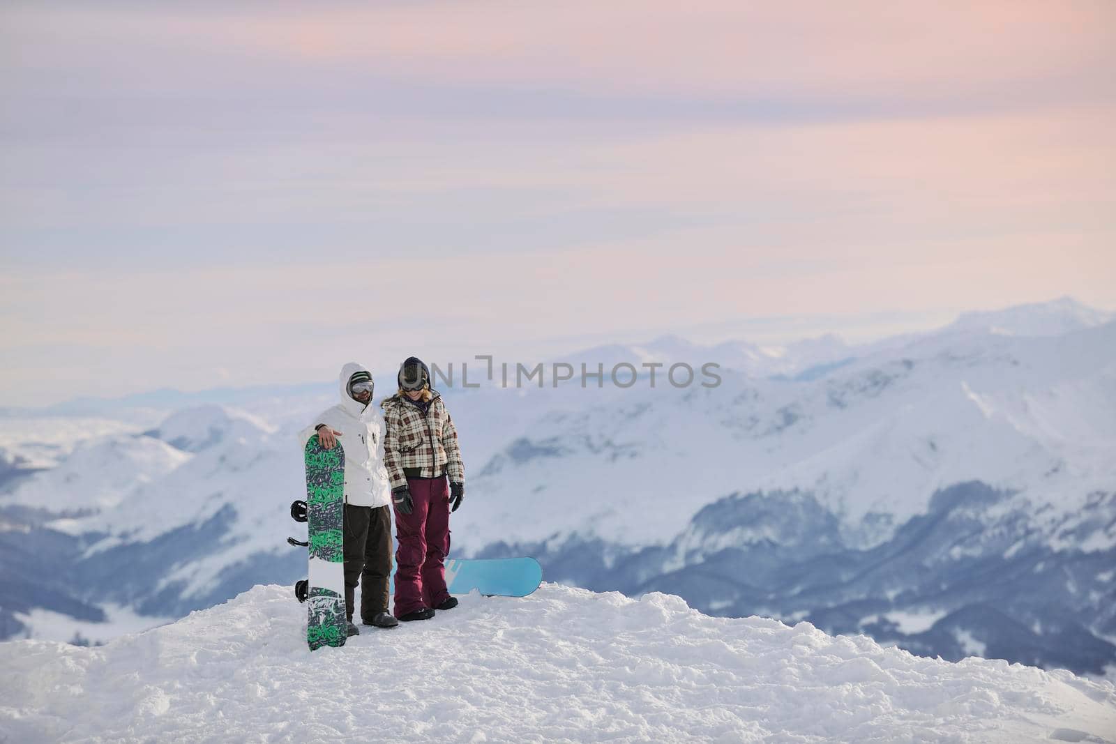snowboarder's couple on mountain's top by dotshock