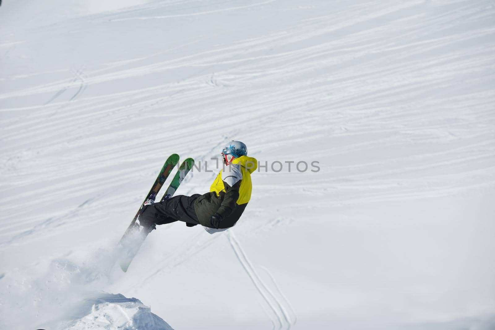 jumping skier at mountain winter snow fresh suny day