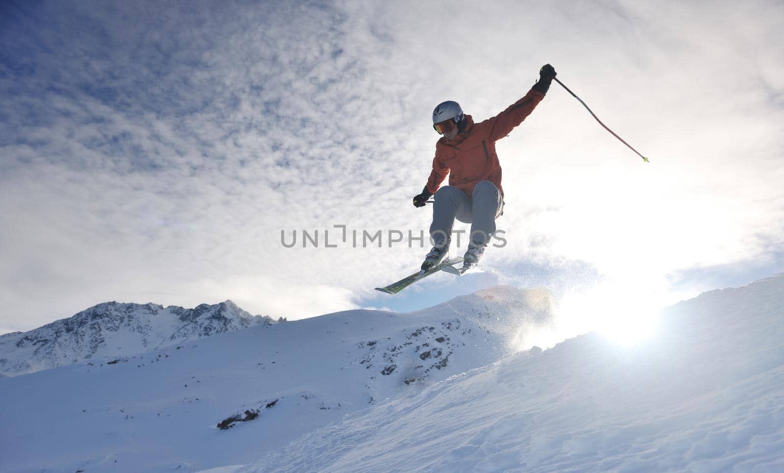 young athlete man have fun during skiing sport on hi mountain slopes at winter seasson and sunny day