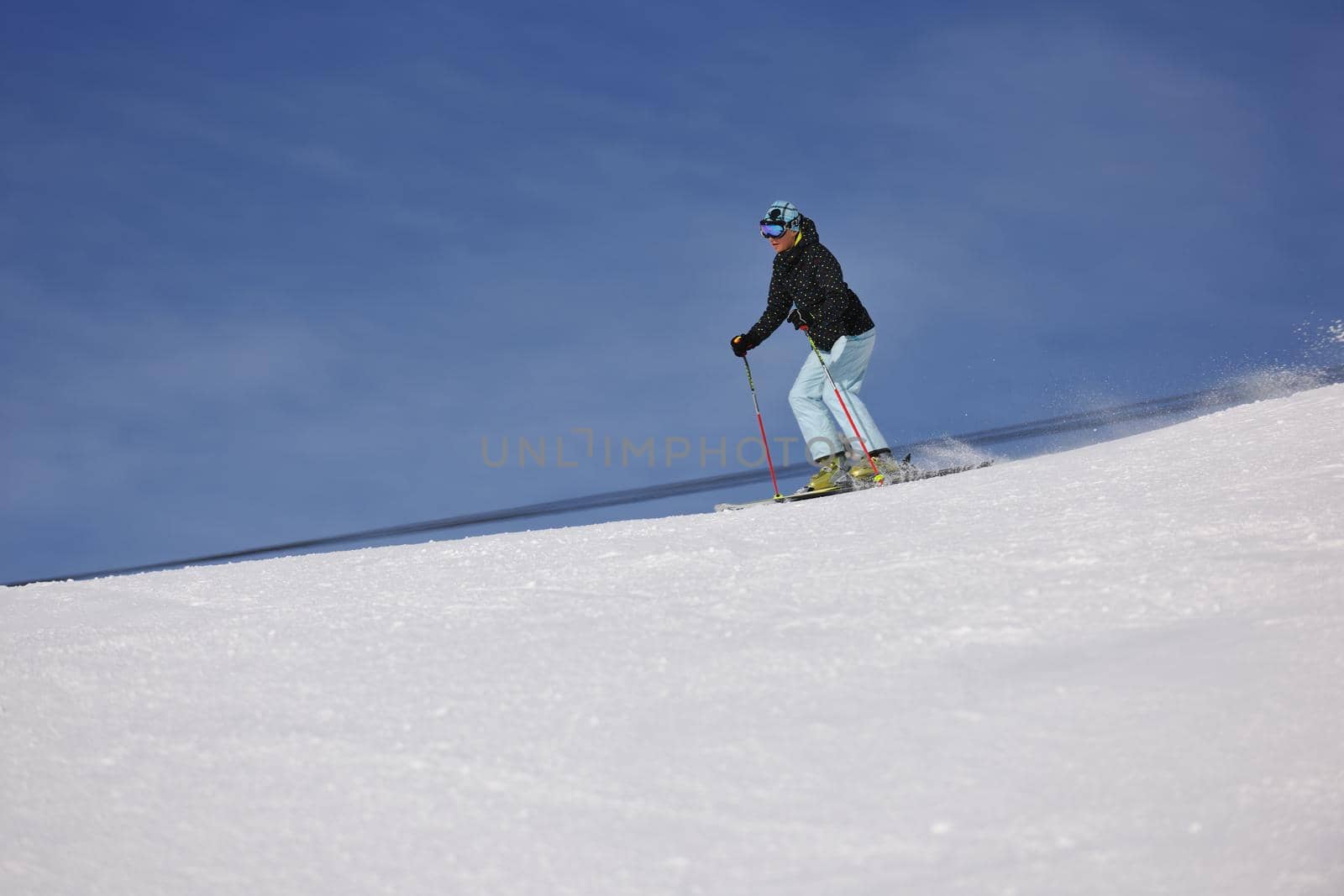 woman skiing on fresh snow at winter season  by dotshock