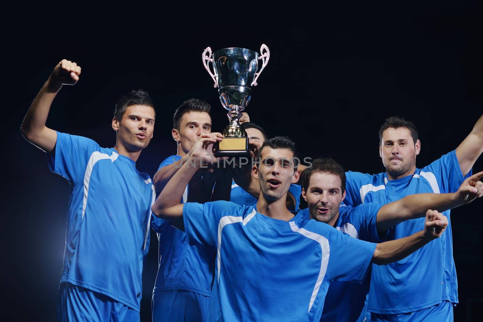 soccer players team group celebrating the victory and become champion of game while holding win coup