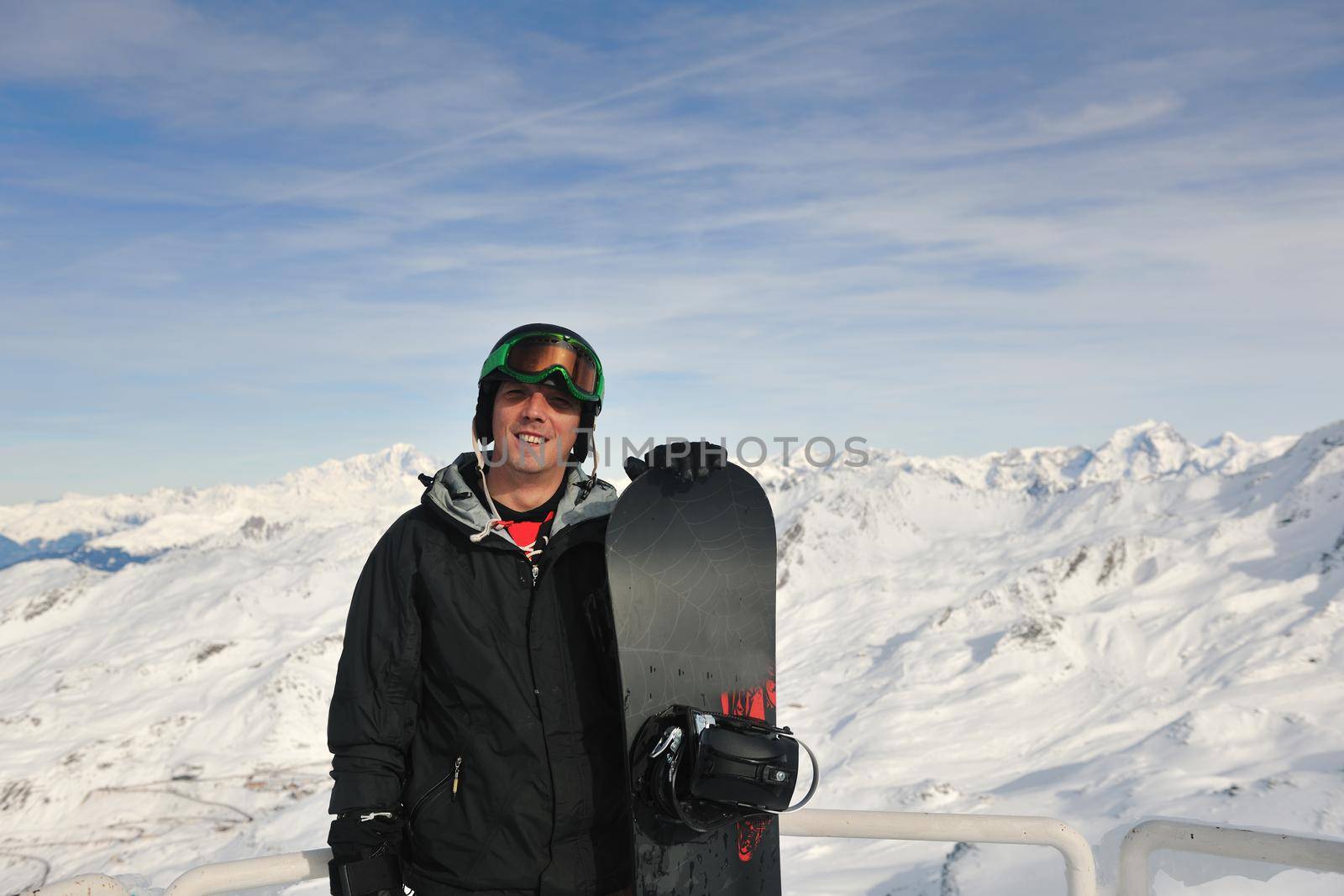 happy young man have fan while relaxing at snow with ski and snowboard sport at winter season