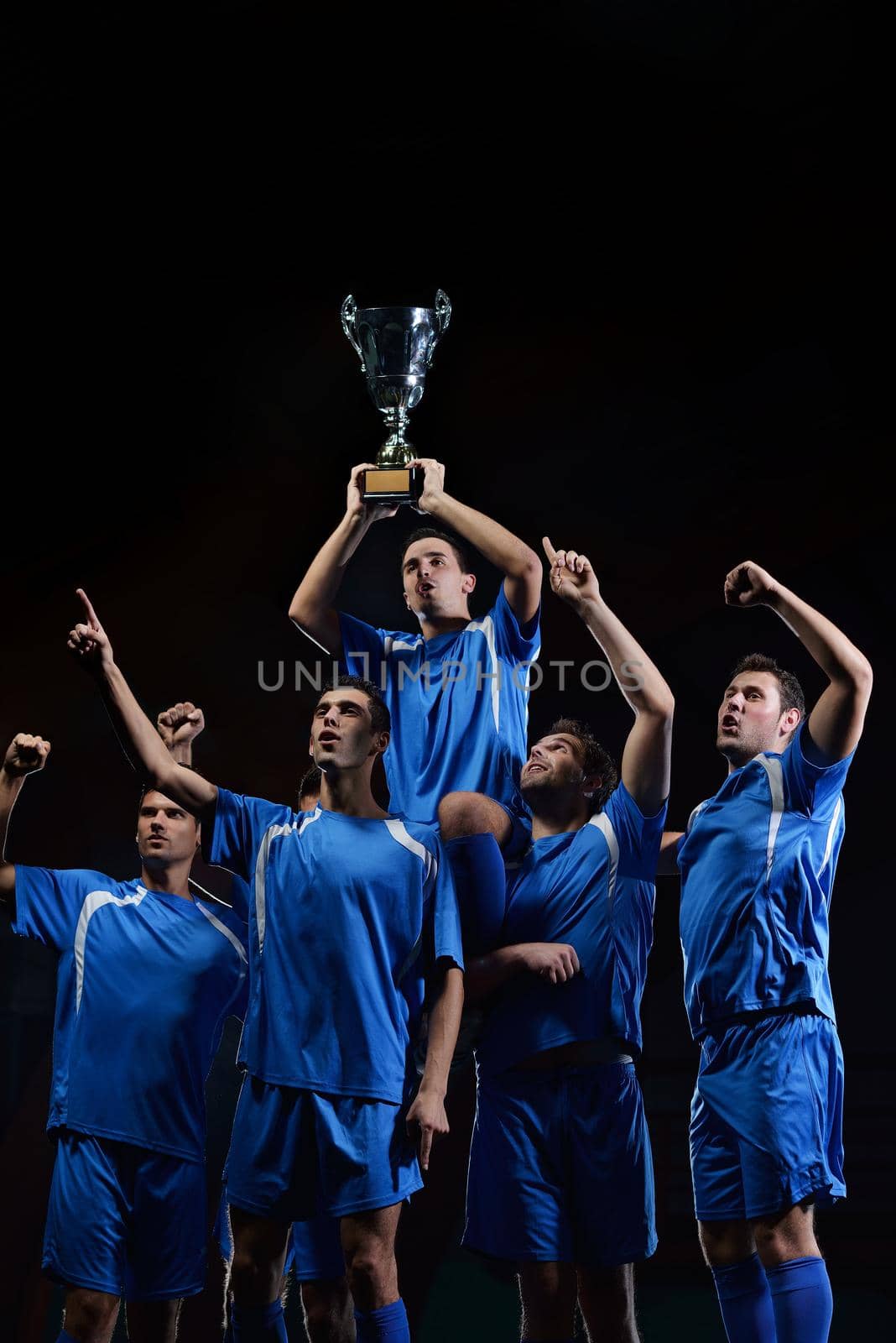 soccer players team group celebrating the victory and become champion of game while holding win coup