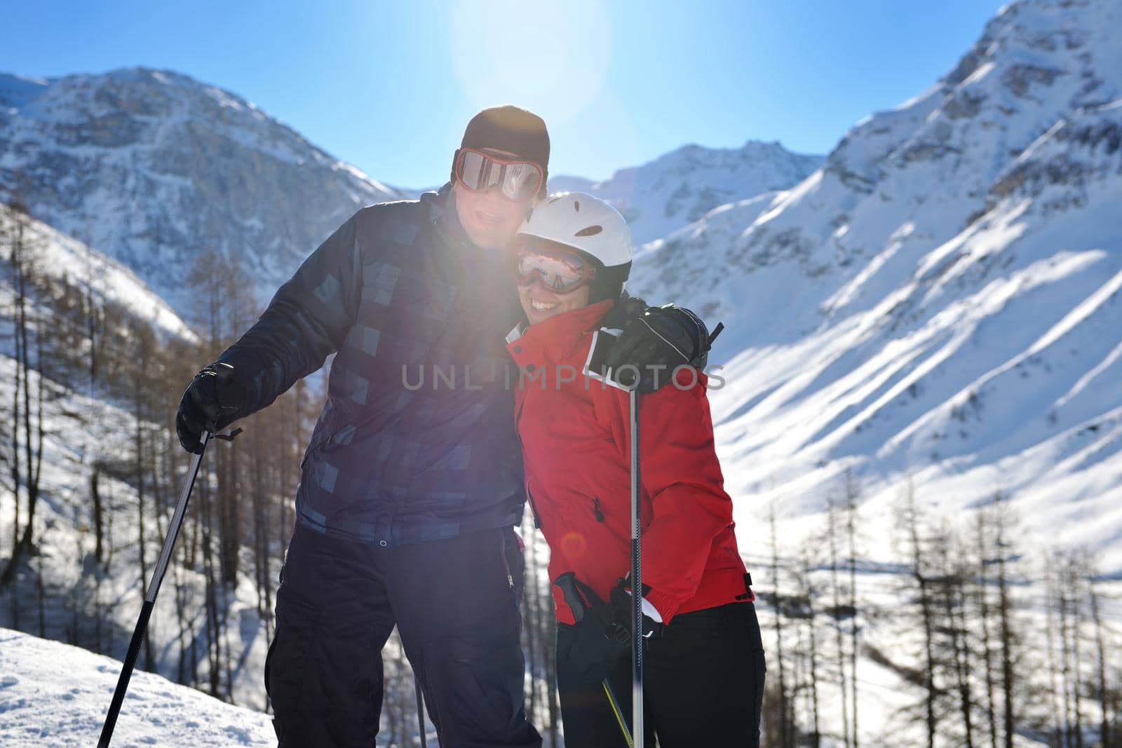 happy people group have fun on snow at winter season on mountain with blue sky and fresh air