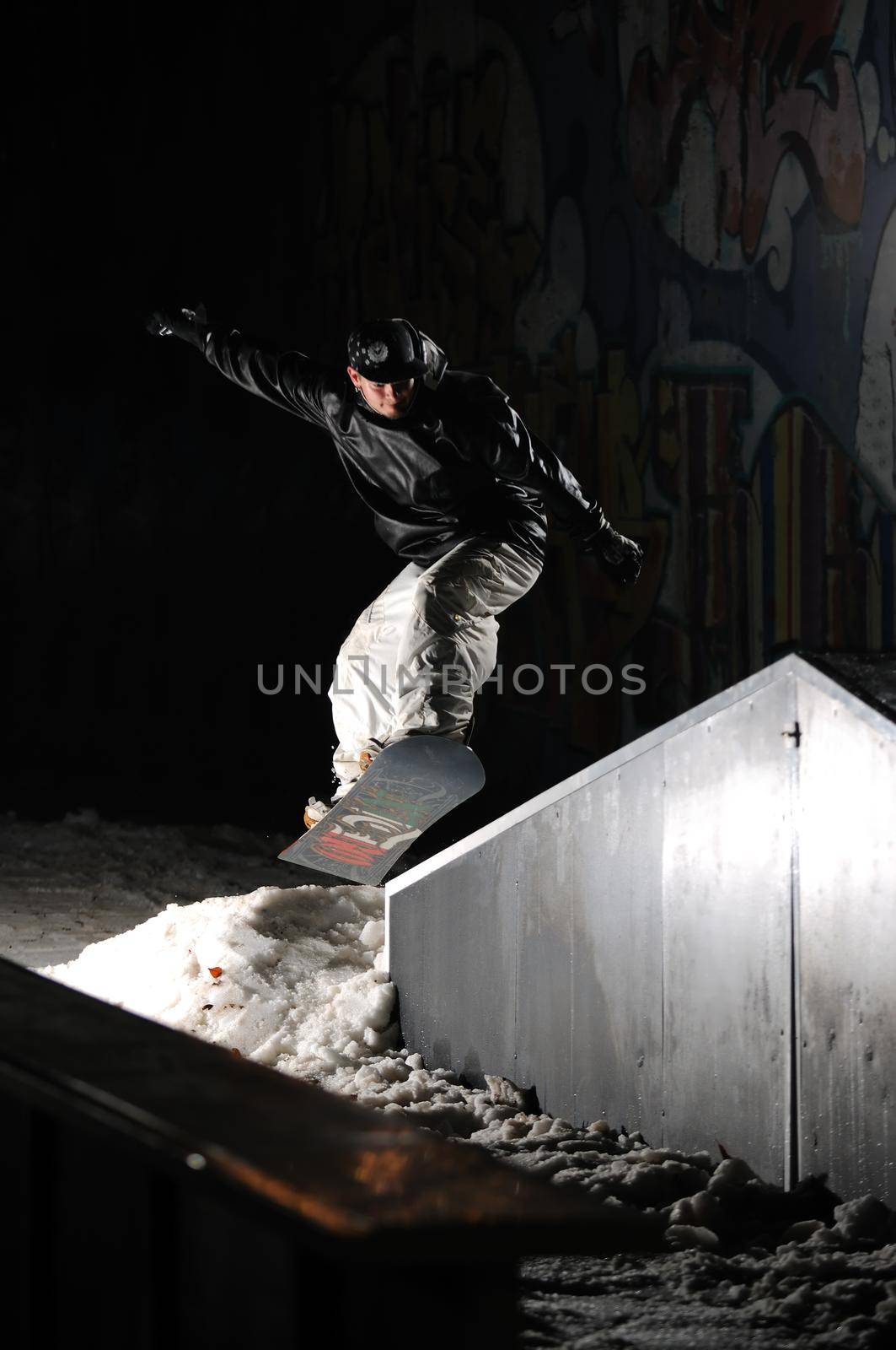 young free style snowboarder jumping in air and make acrobations