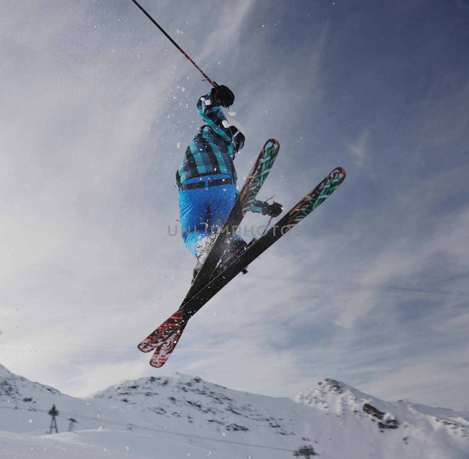 extreme freestyle ski jump with young man at mountain in snow park at winter season