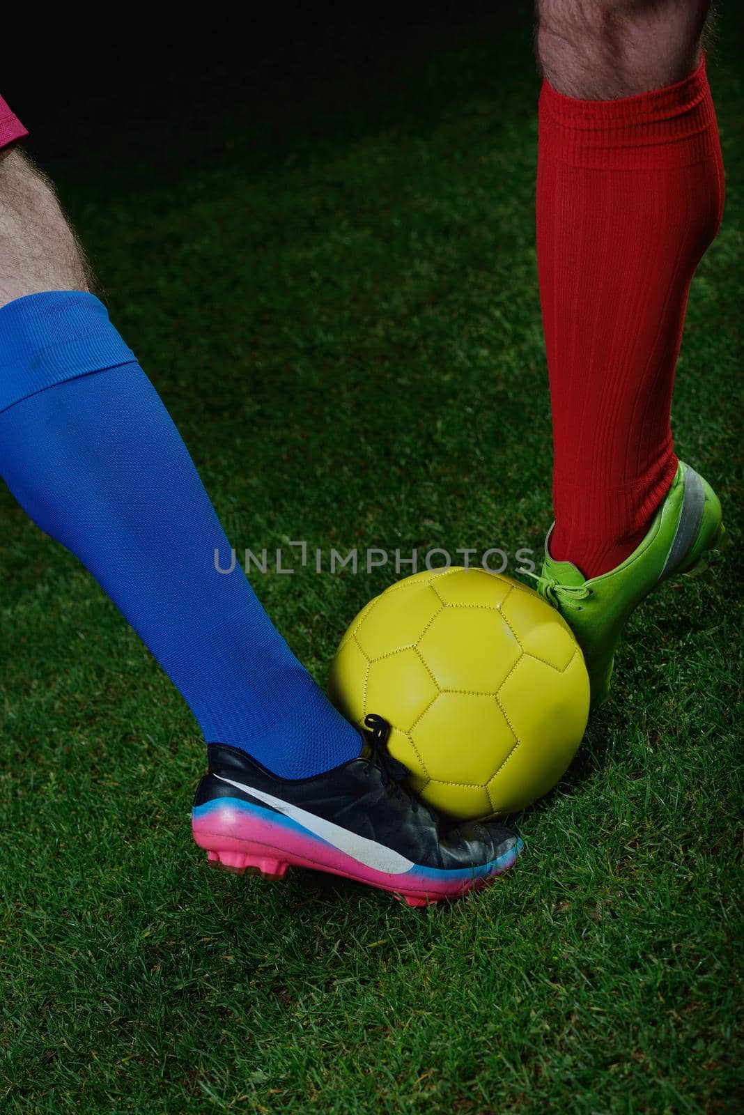 soccer player doing kick with ball on football stadium  field  isolated on black background