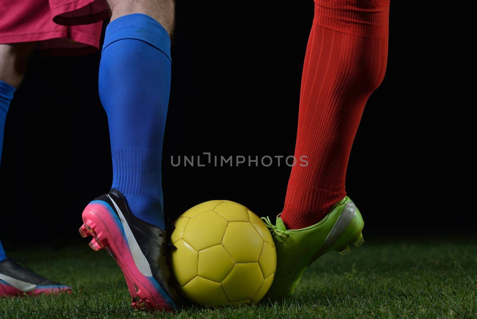 soccer player doing kick with ball on football stadium  field  isolated on black background