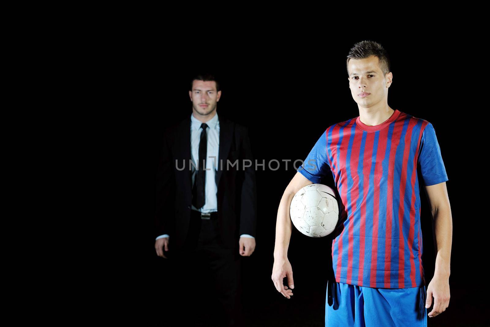 soccer  sport manager in business suit coach and football player on stadium with green grass and white ball