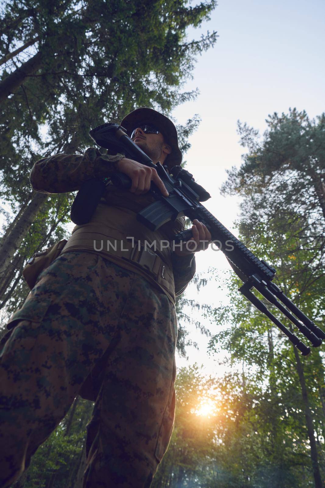 soldier portrait with  protective army tactical gear  and weapon having a break and relaxing