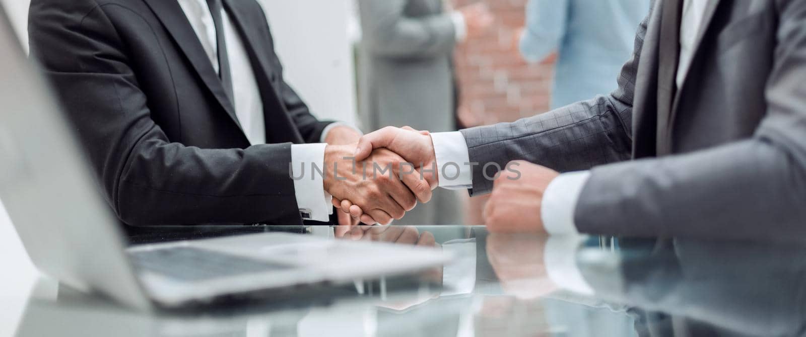 close up. handshake of business people near the office table by asdf
