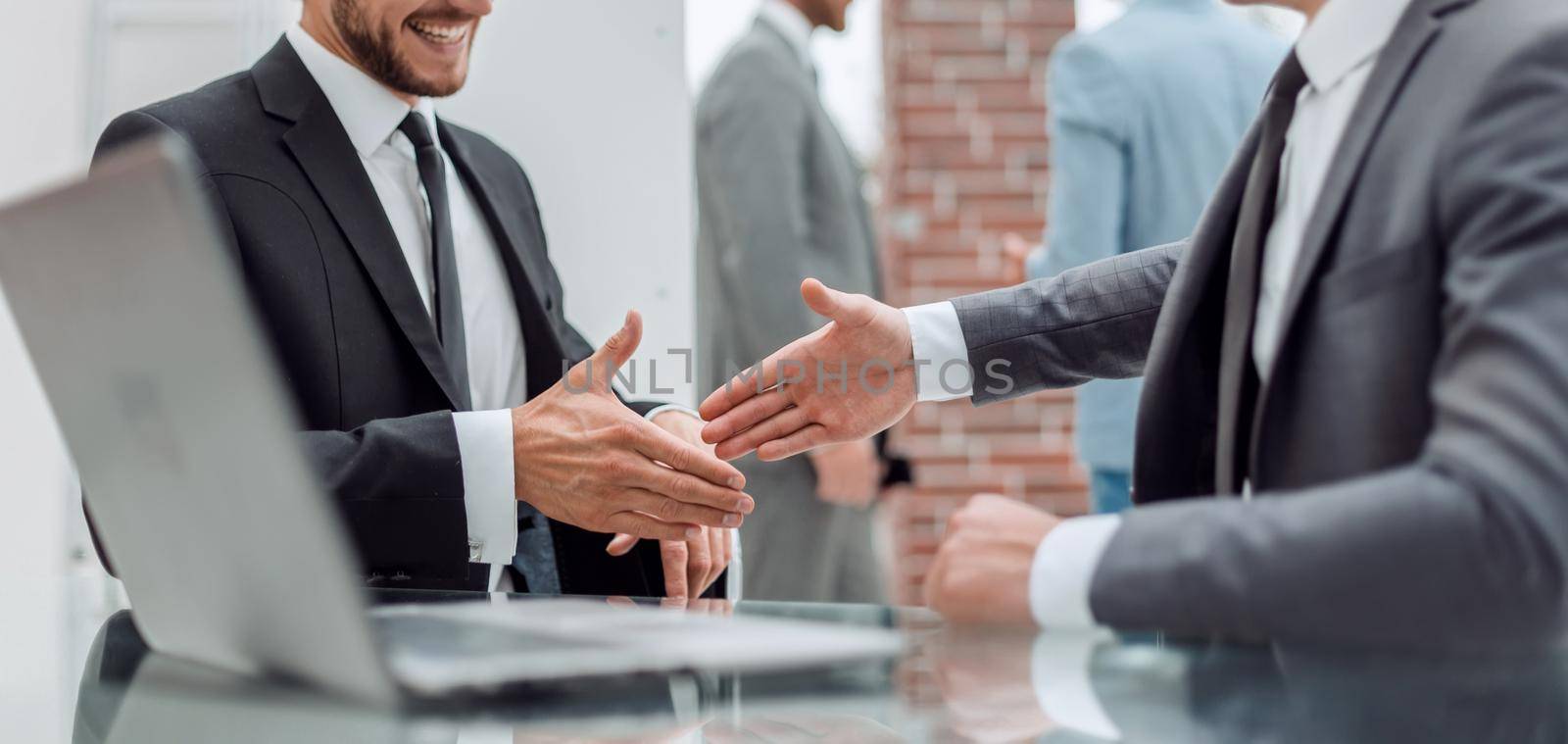 close up. business people holding out their hands for a handshake. concept of partnership