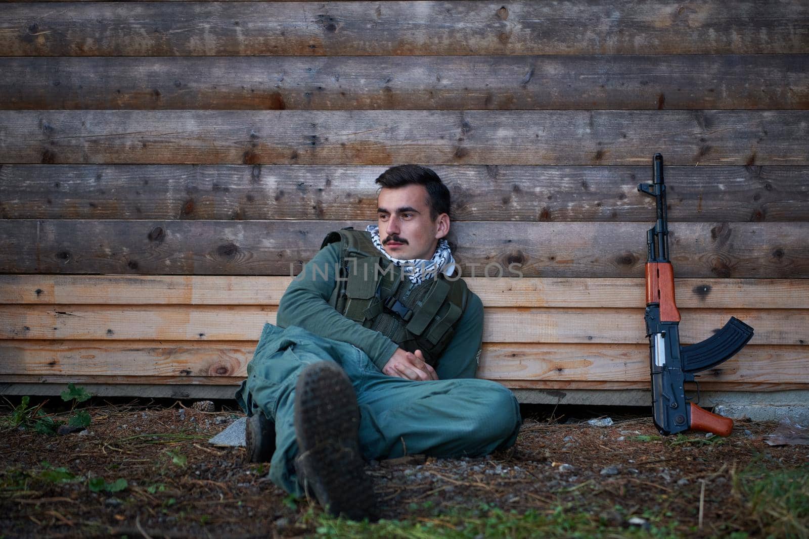 terrorist have a break and smoke cigarette in forest during battle