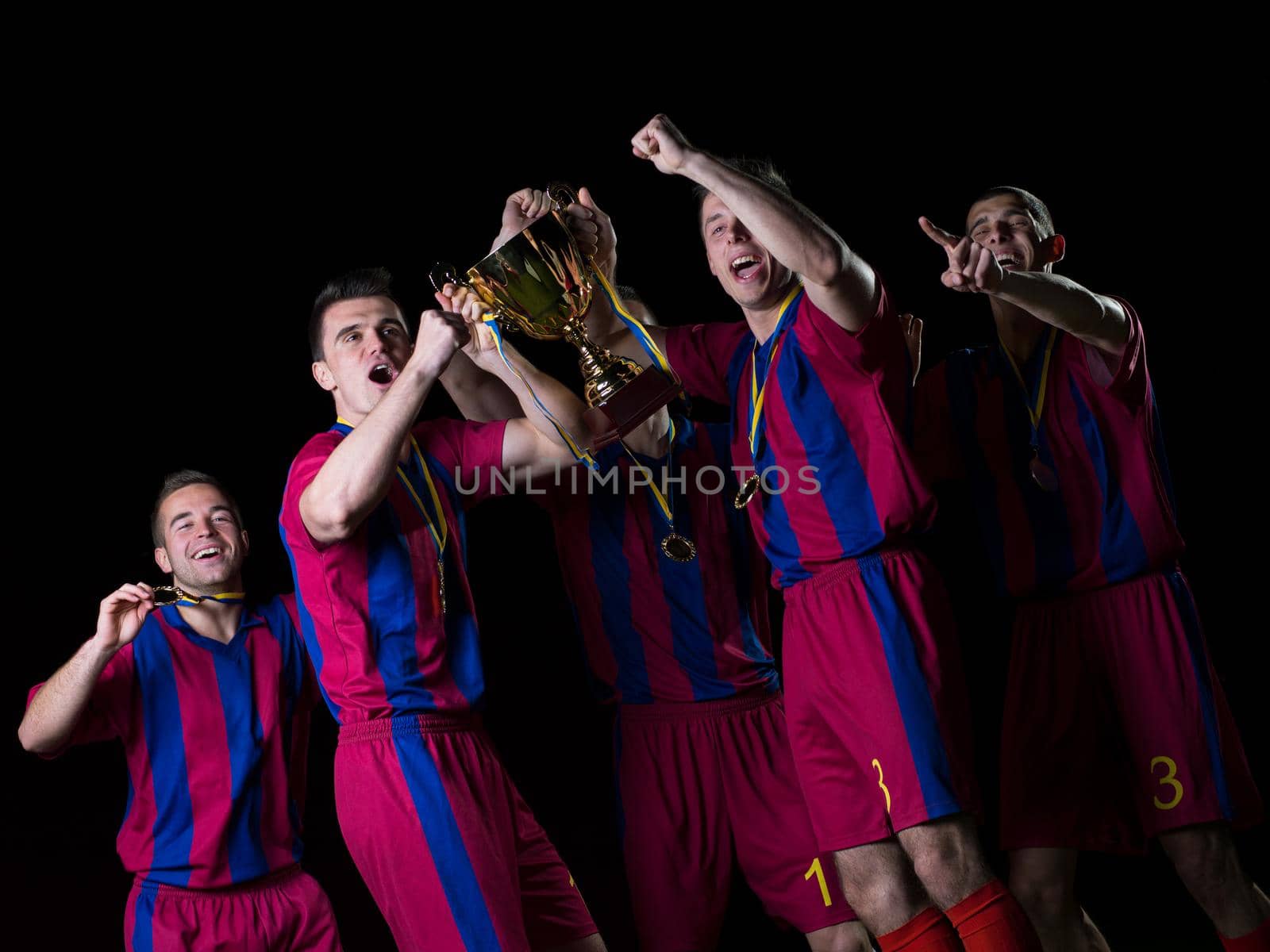 soccer players team group celebrating the victory and become champion of game while holding win coup