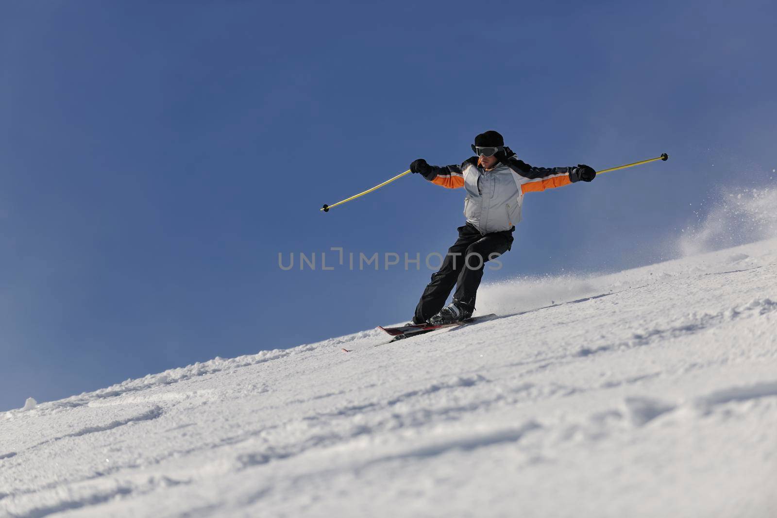 man ski free ride downhill at winter season on beautiful sunny day and powder snow