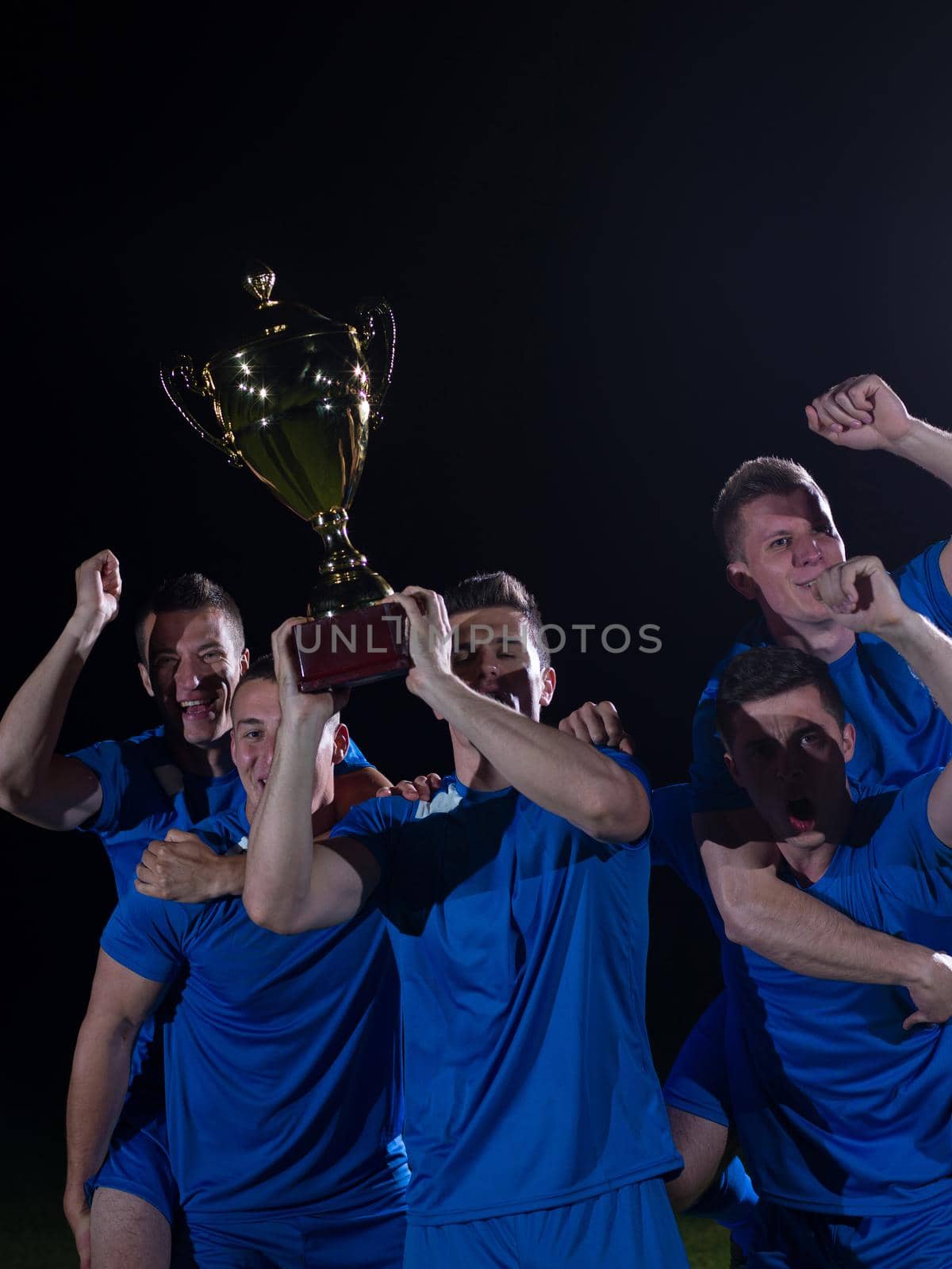 soccer players team group celebrating the victory and become champion of game while holding win coup