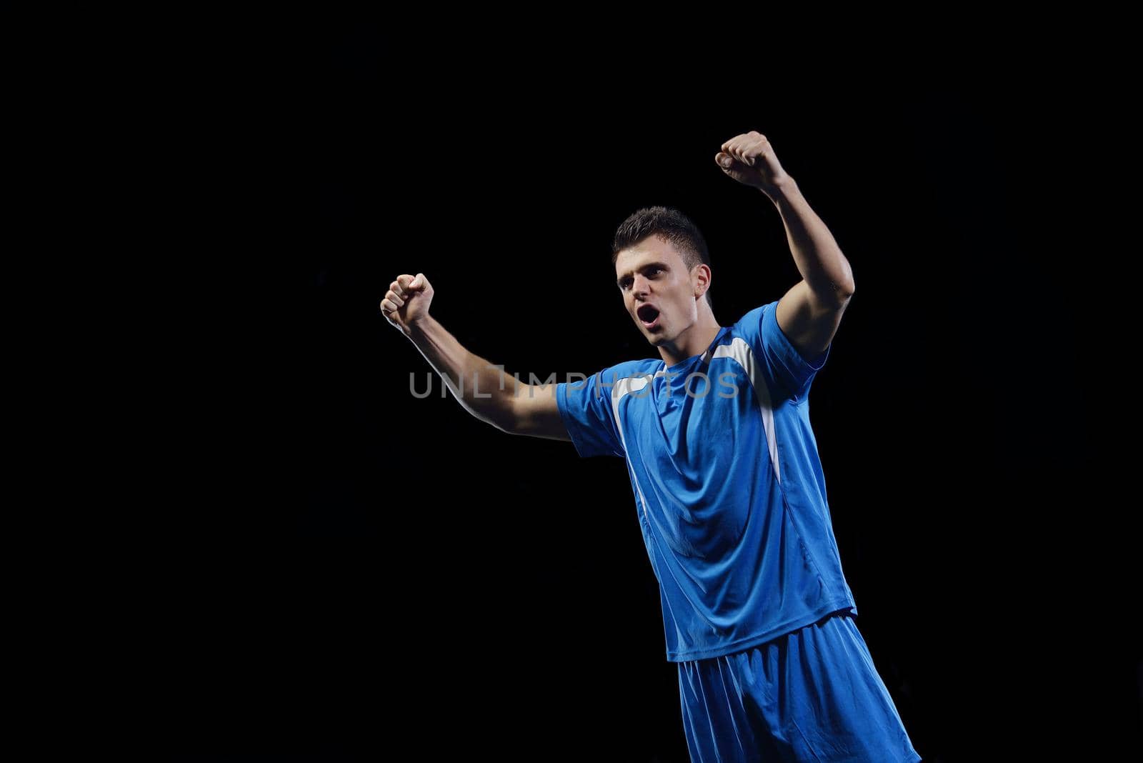 soccer player doing kick with ball on football stadium  field  isolated on black background