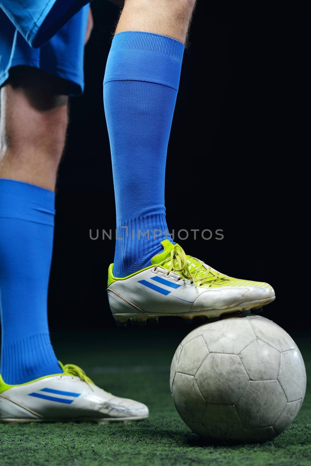 soccer player doing kick with ball on football stadium  field  isolated on black background