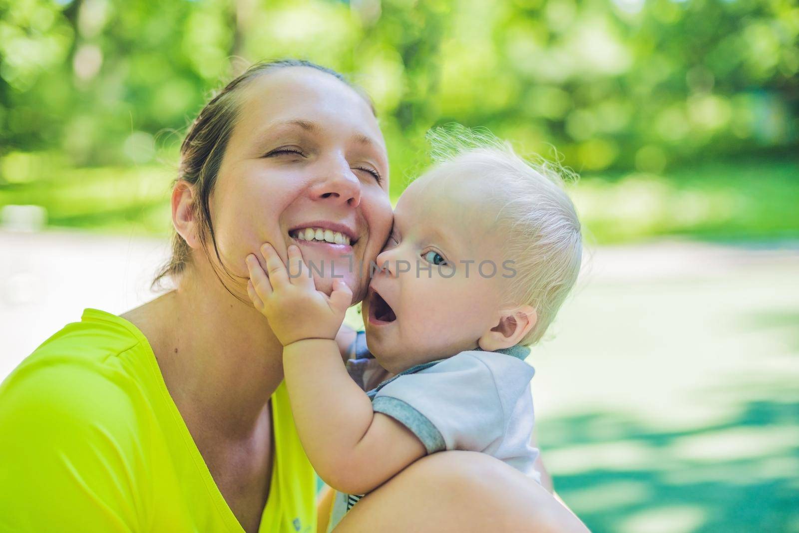 happy loving young mother and her toddler son on the walk.