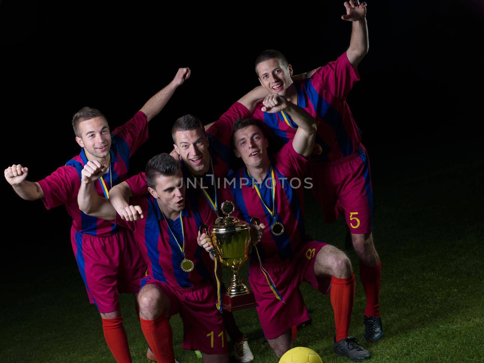 soccer players team group celebrating the victory and become champion of game while holding win coup