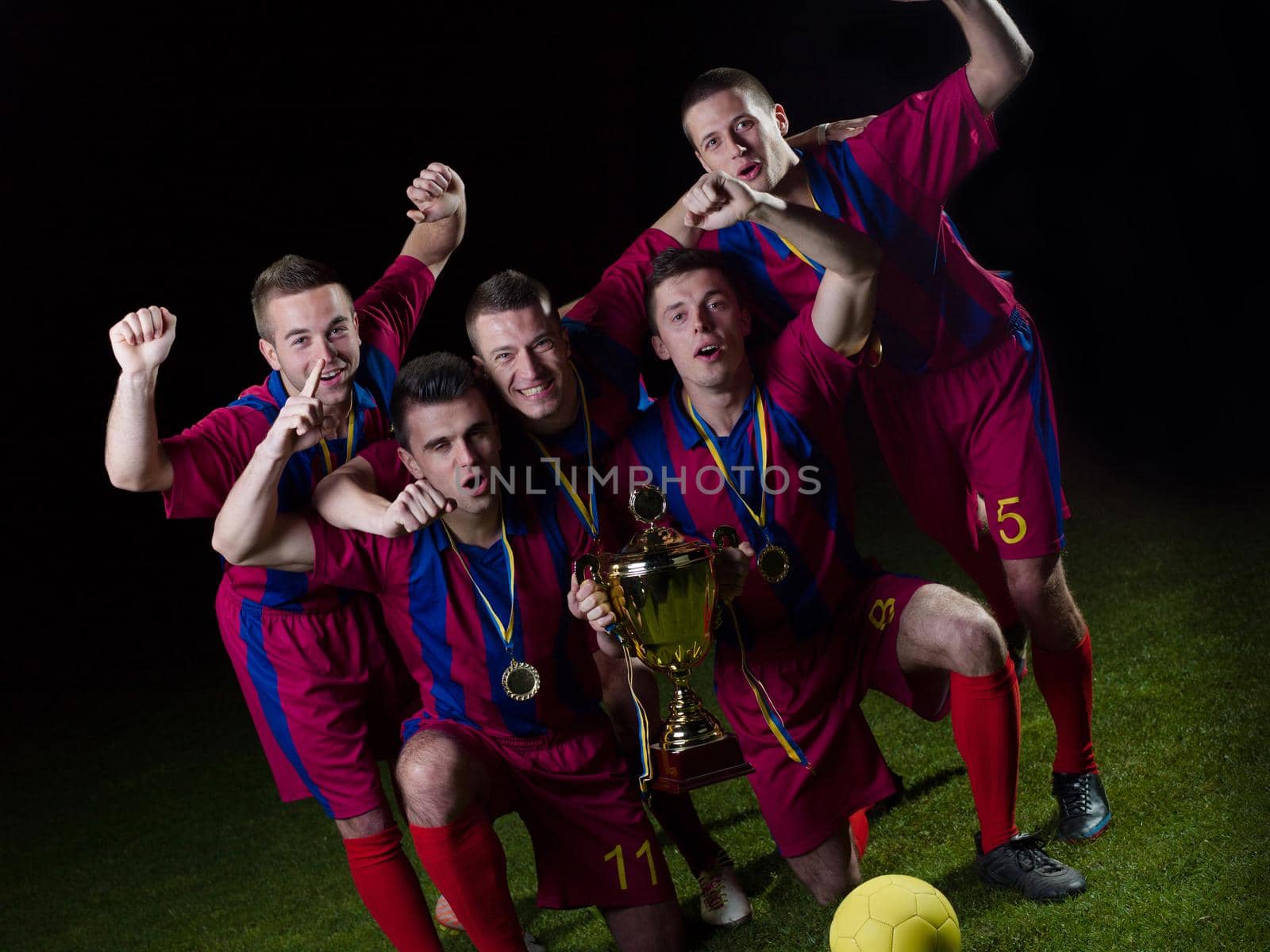 soccer players team group celebrating the victory and become champion of game while holding win coup