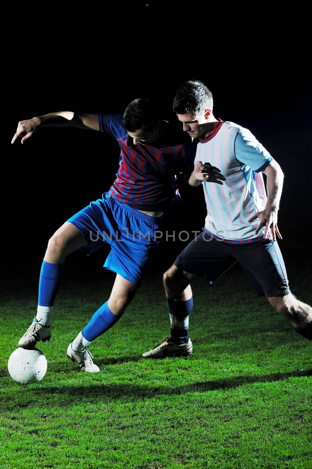 competition Action run and jump Duel of football players at soccer ball stadium at night