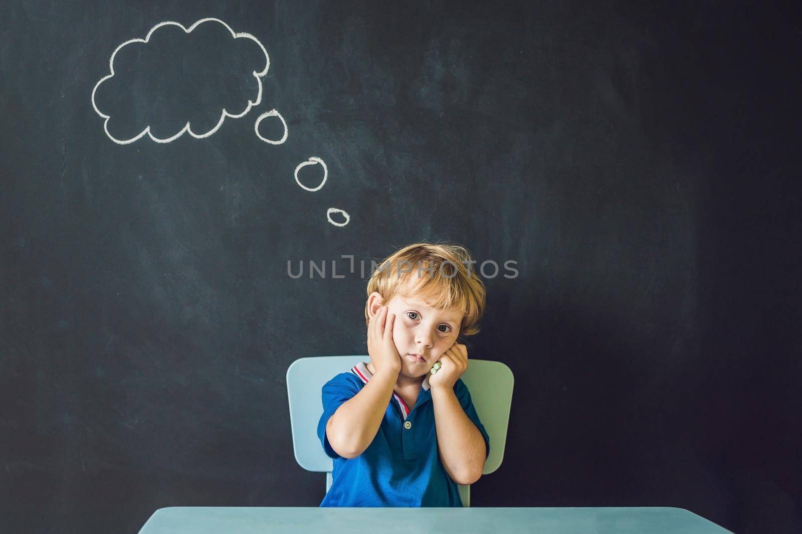 Closeup portrait of Cute little boy thinking deeply about something Copy space by galitskaya