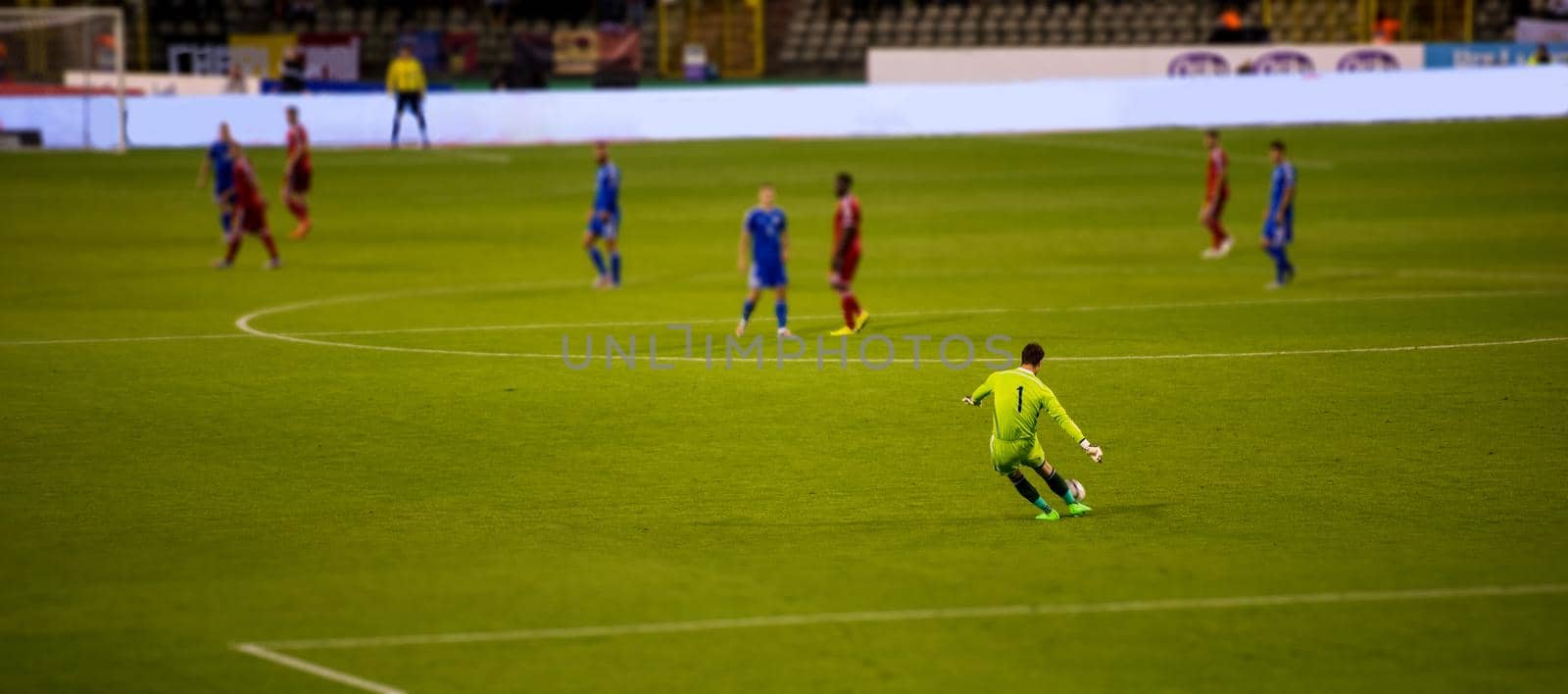 Soccer goalkeeper kicks out the ball during the match at stadium