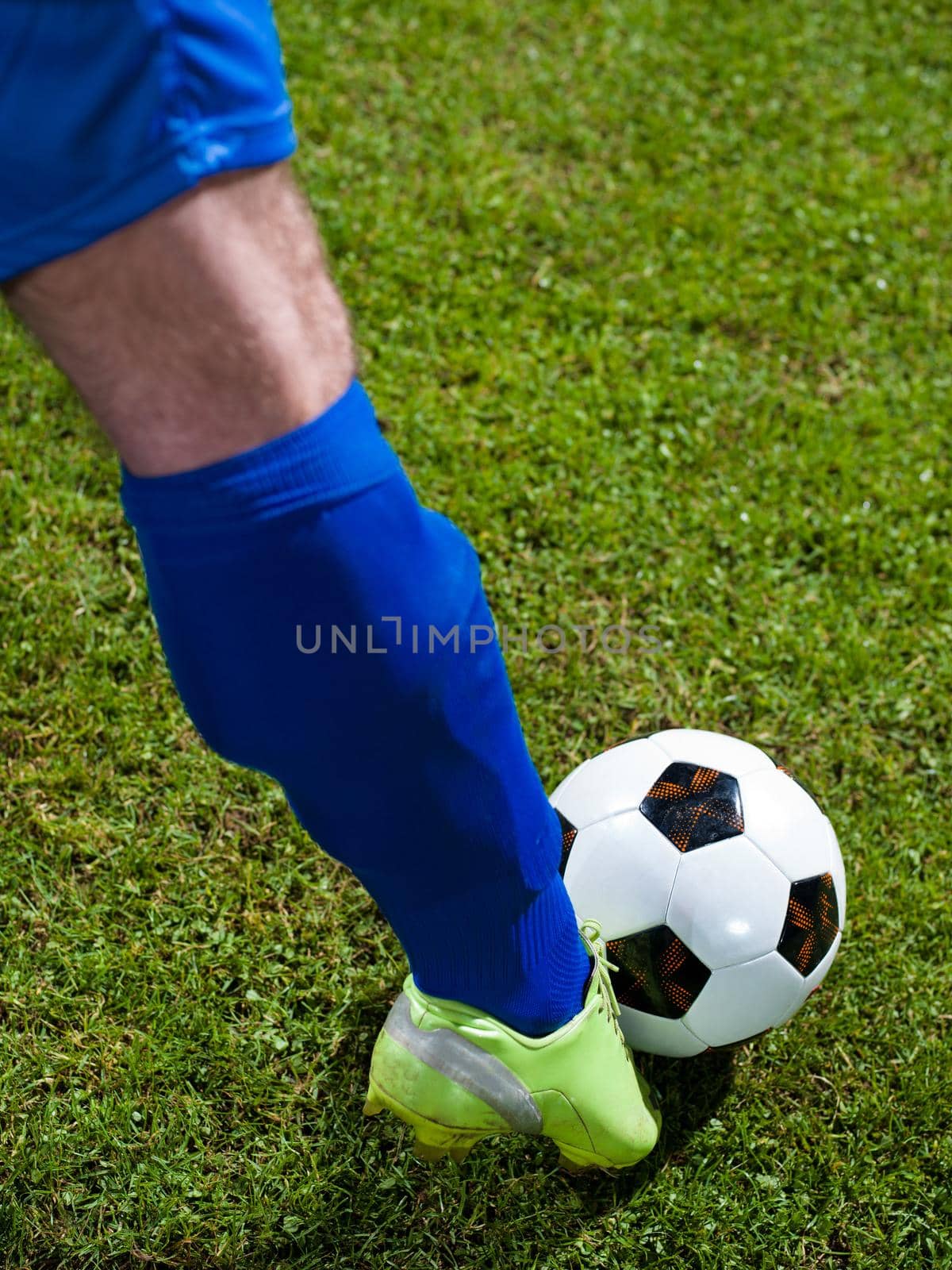 soccer player doing kick with ball on football stadium  field  isolated on black background