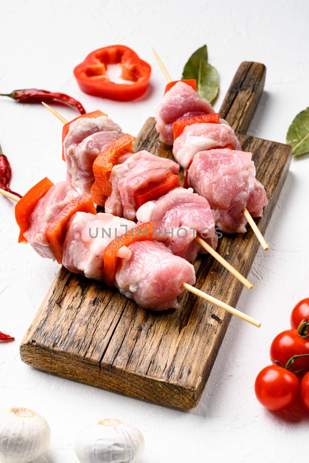 Uncooked Raw meat Chopsticks set, on white stone table background