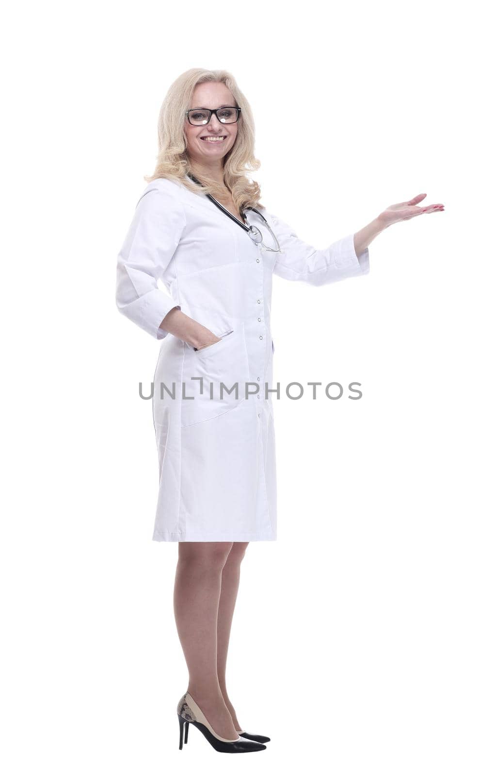 in full growth.a smiling female doctor pointing at a white blank screen . isolated on a white