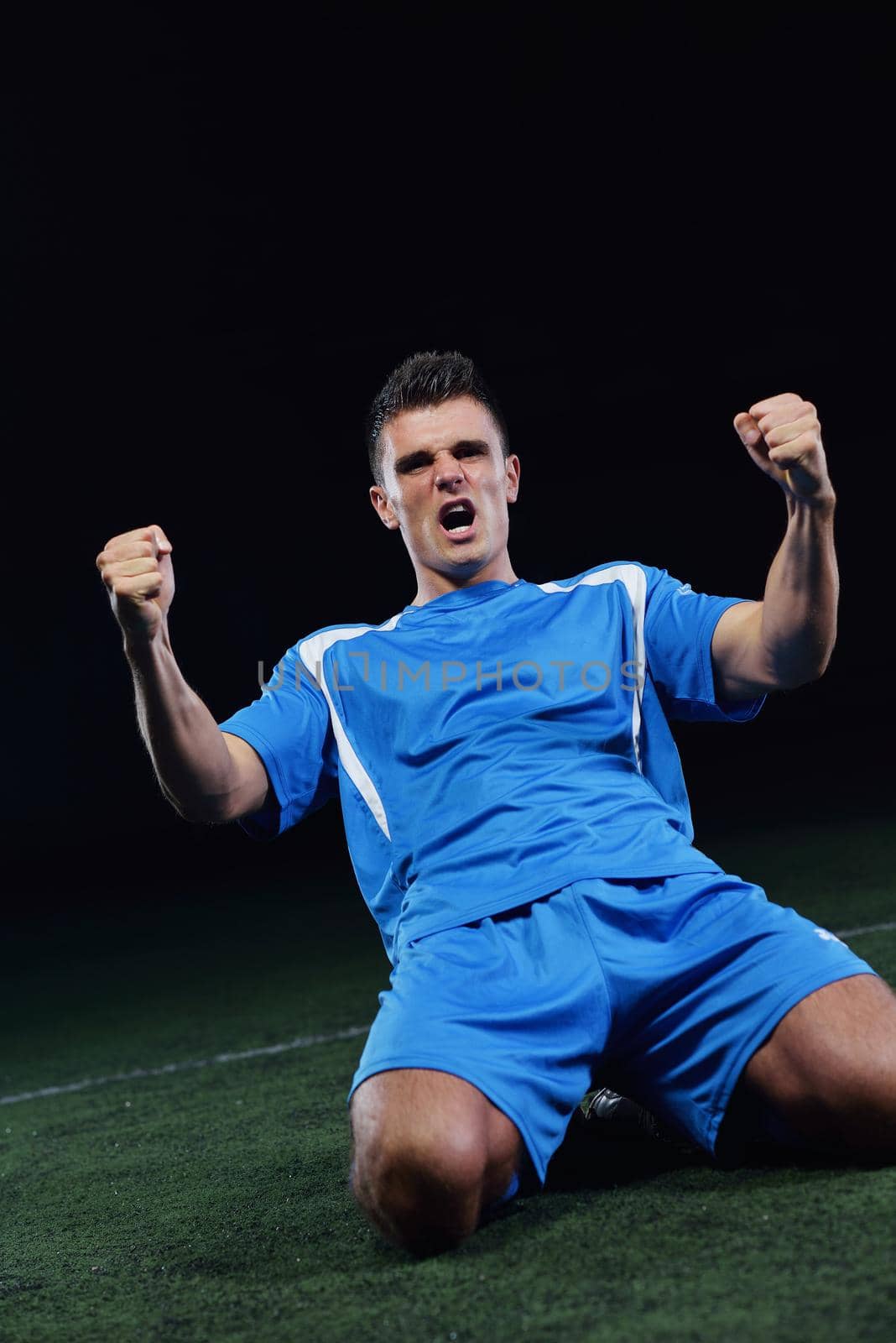 soccer player doing kick with ball on football stadium  field  isolated on black background