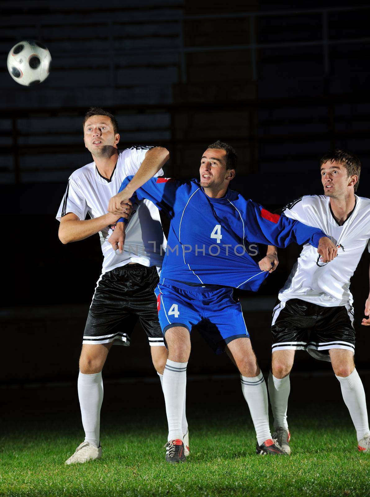 competition Action run and jump Duel of football players at soccer ball stadium at night