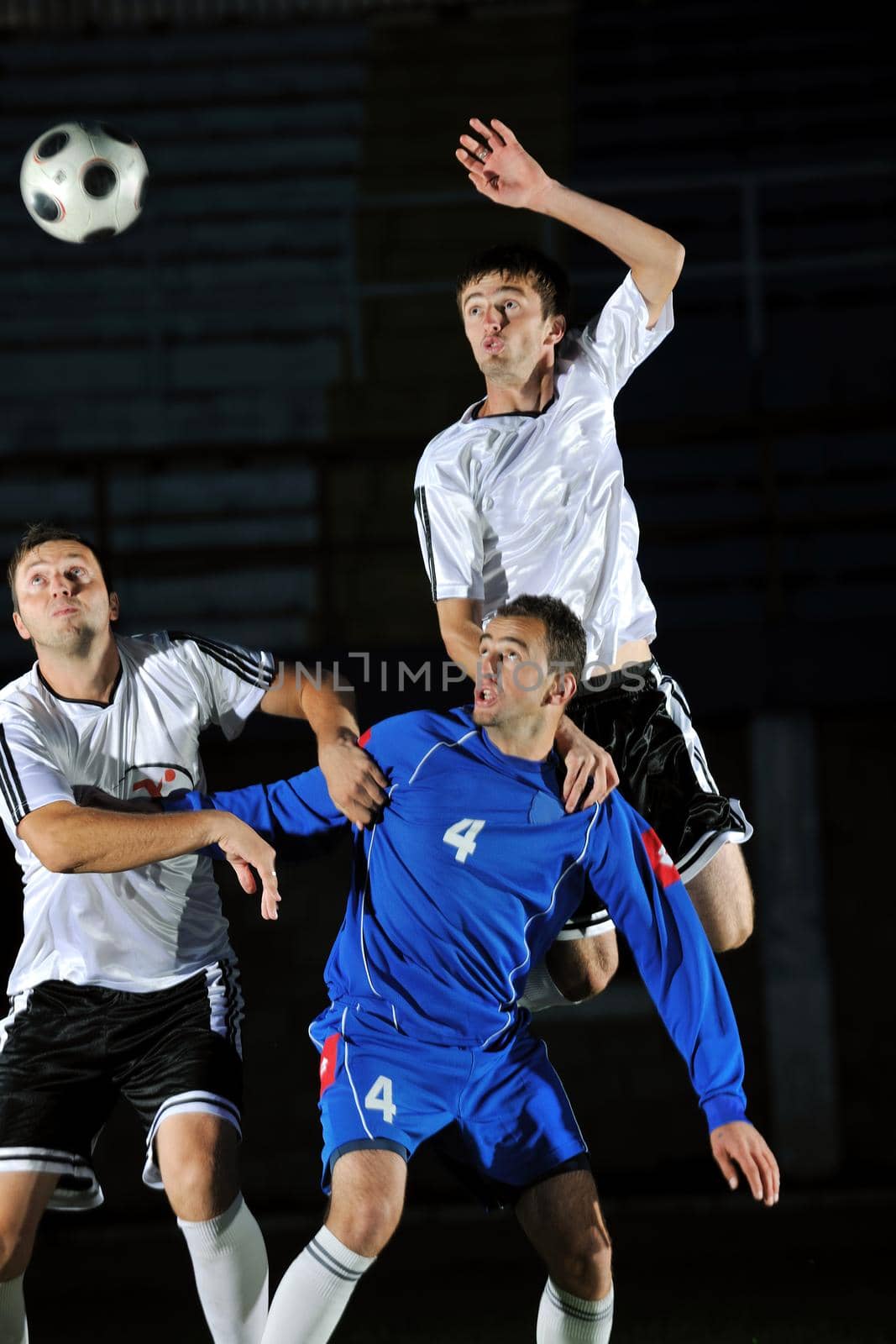 competition Action run and jump Duel of football players at soccer ball stadium at night