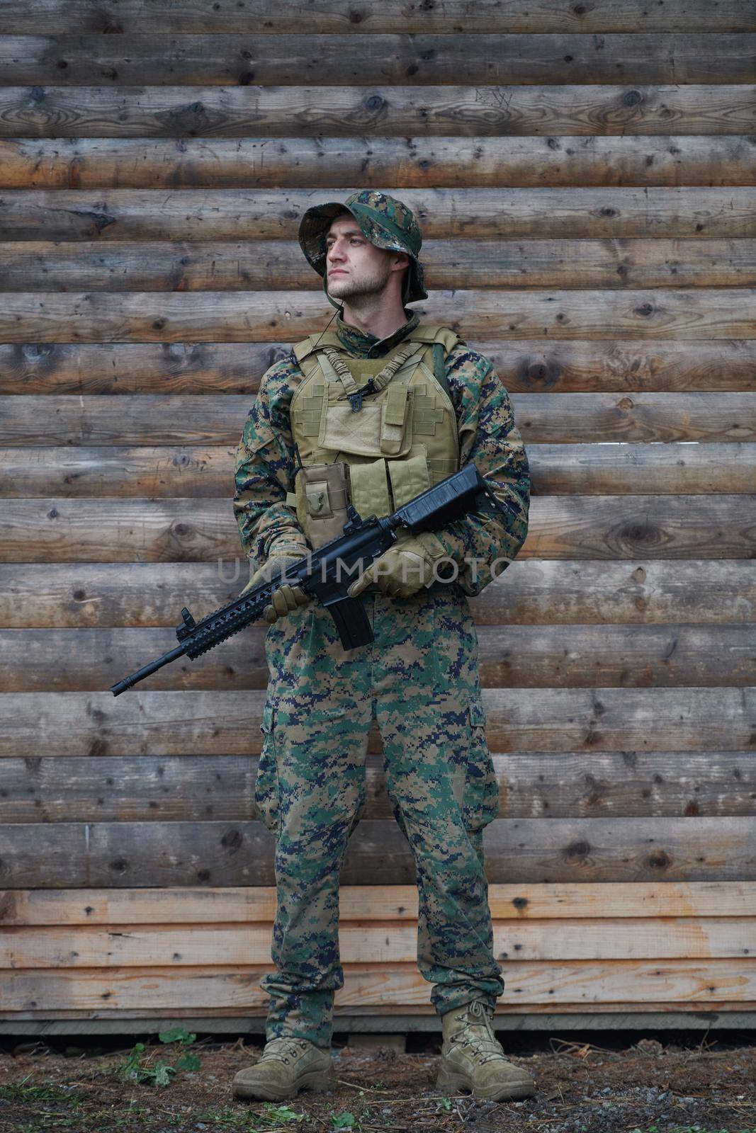 soldier portrait with  protective army tactical gear  and weapon having a break and relaxing