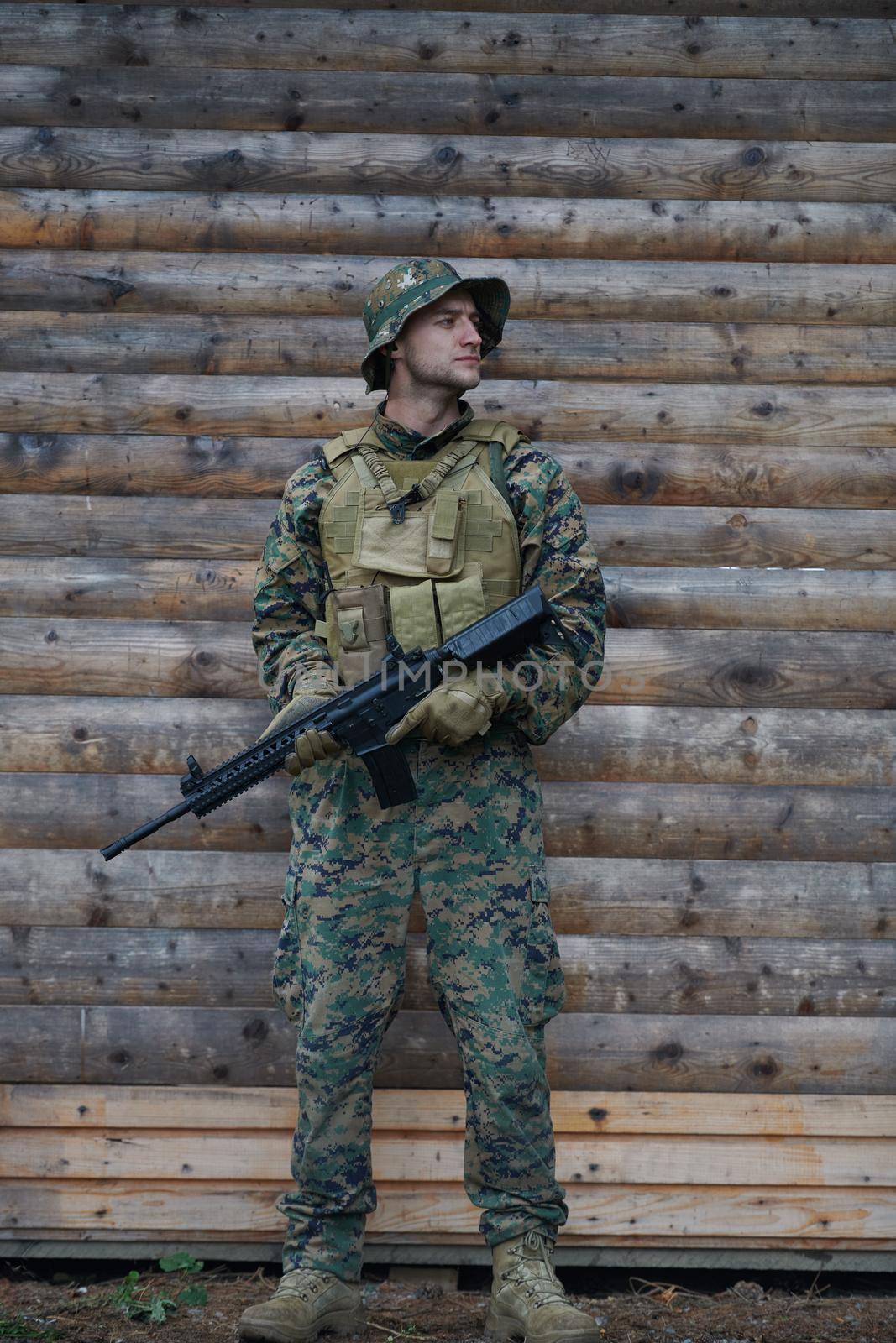 soldier portrait with  protective army tactical gear  and weapon having a break and relaxing