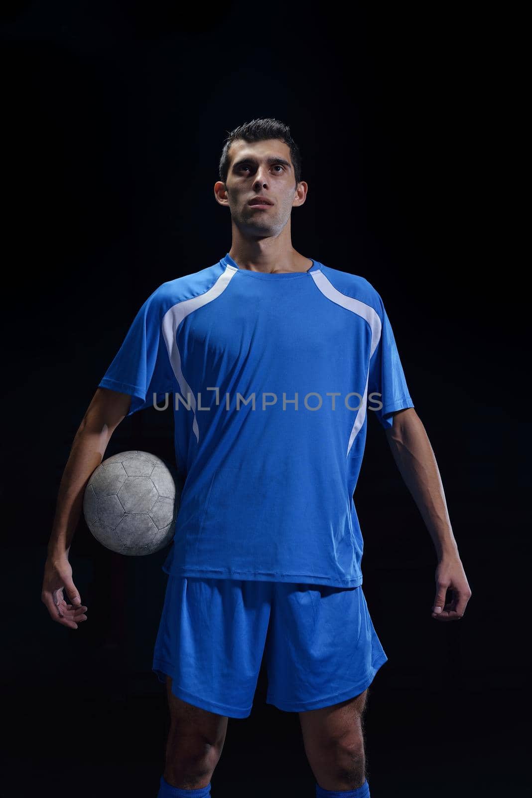 soccer player doing kick with ball on football stadium  field  isolated on black background