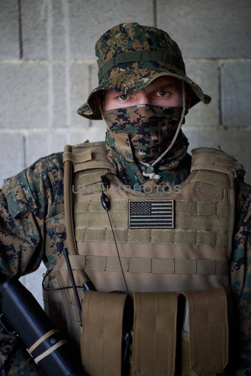 soldier portrait with  protective army tactical gear  against old brick wall