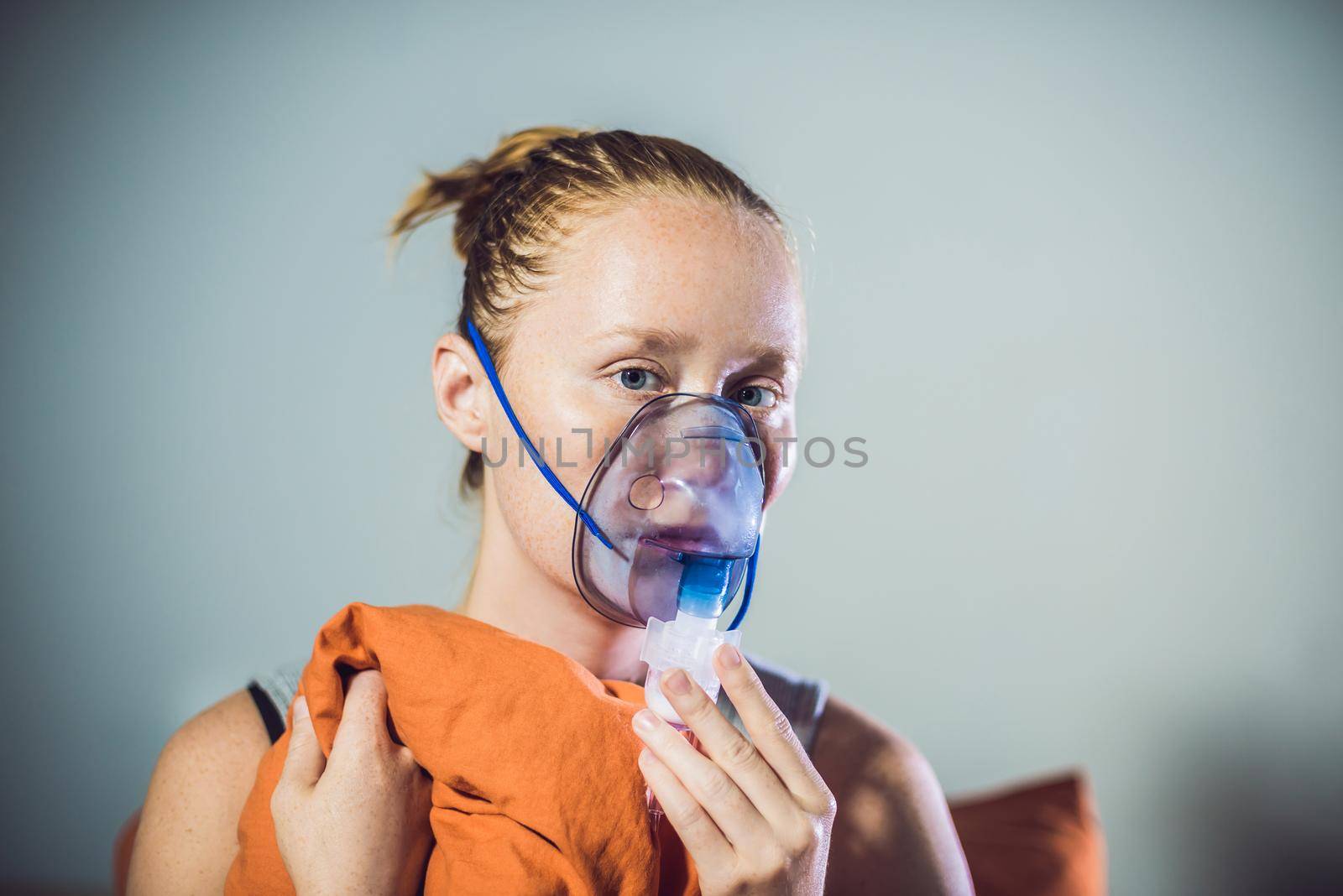 Woman with flu or cold symptoms making inhalation with nebulizer - medical inhalation therapy by galitskaya