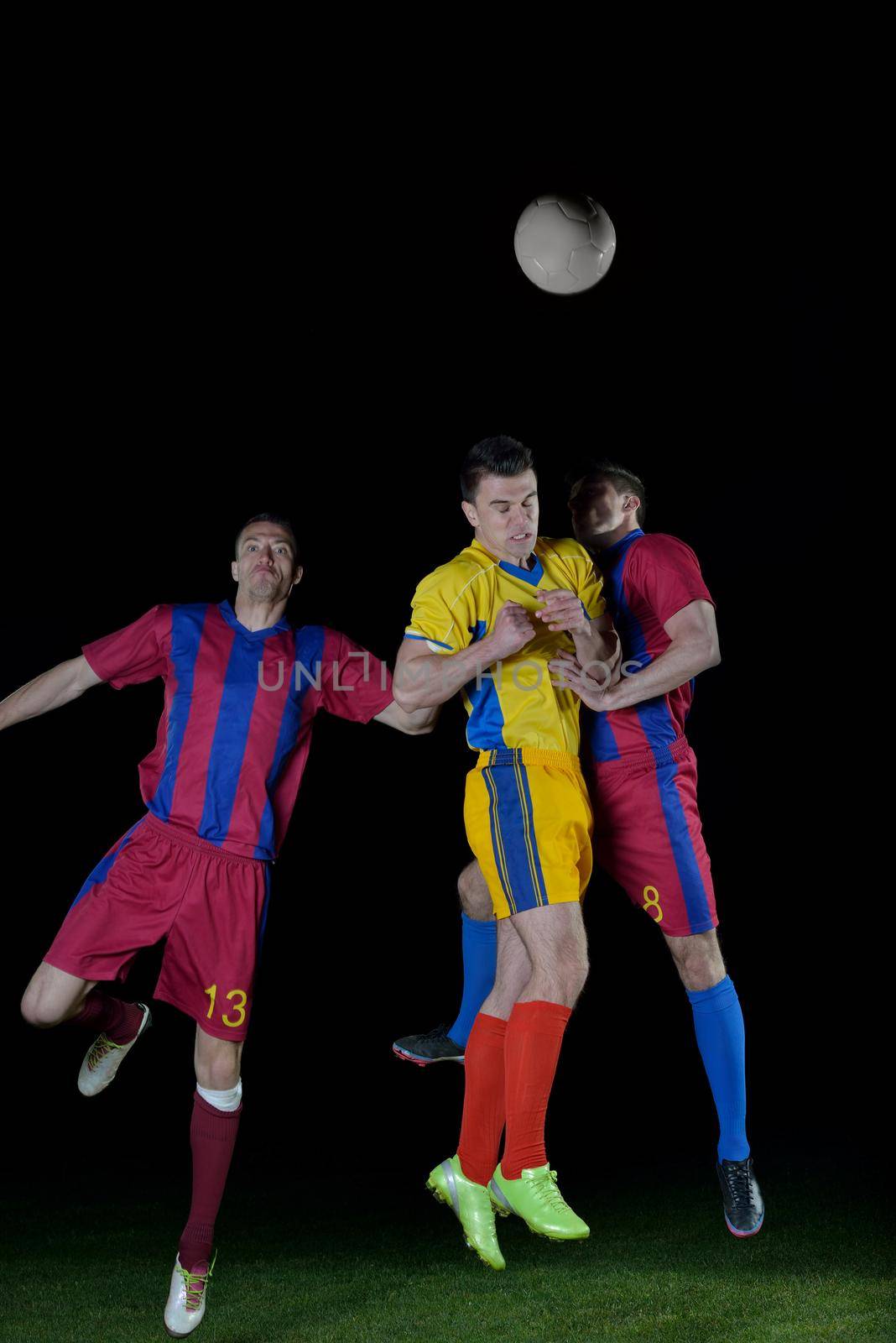 soccer player doing kick with ball on football stadium  field  isolated on black background