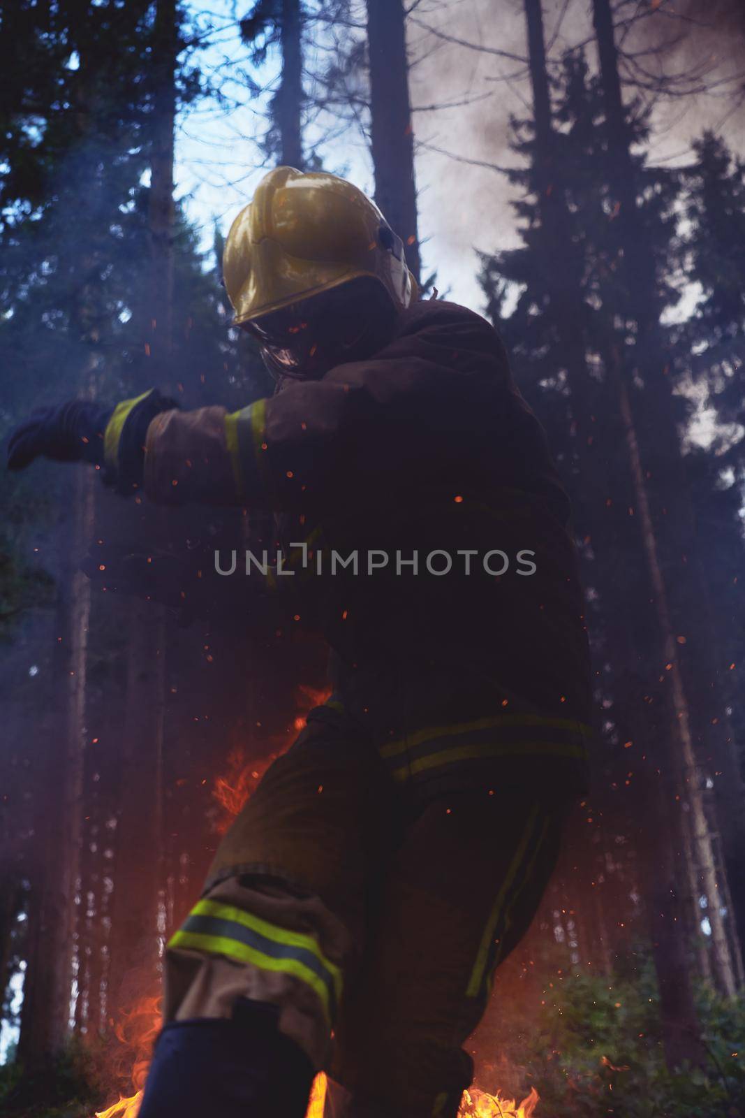 firefighter hero in action danger  jumping over fire flame to rescue and save