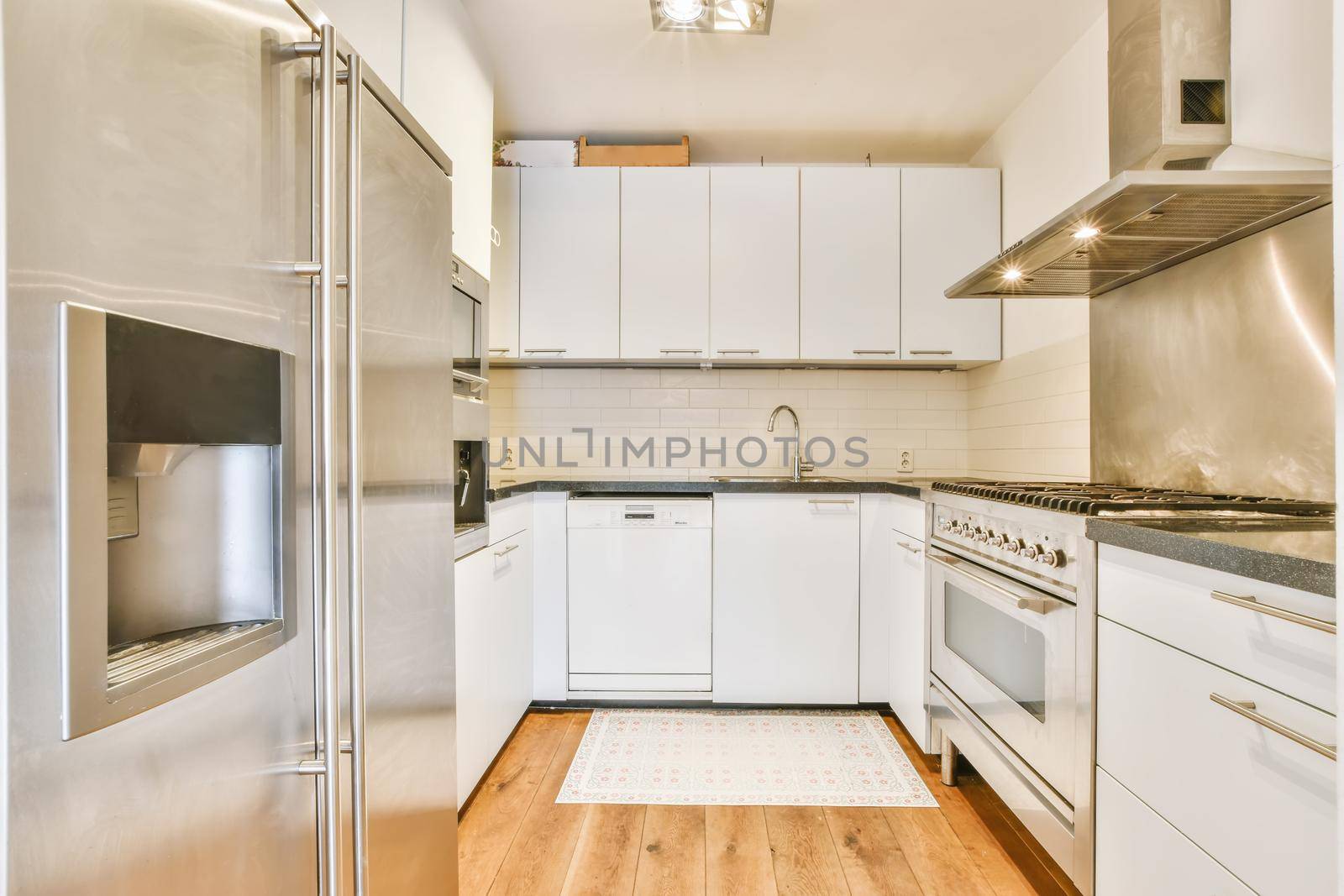 Interior of stylish kitchen with modern furniture and appliances at home