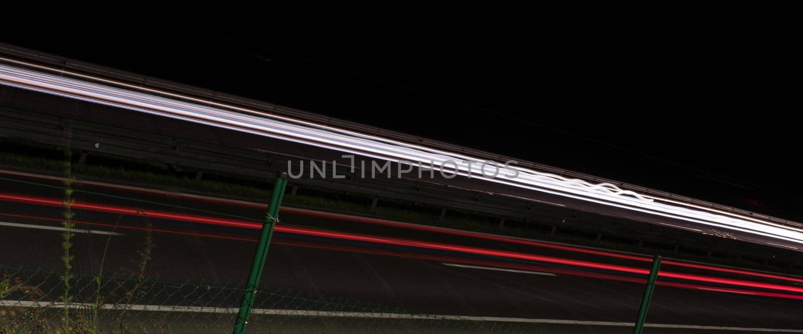 abstract background with car light trails in night on fast highway