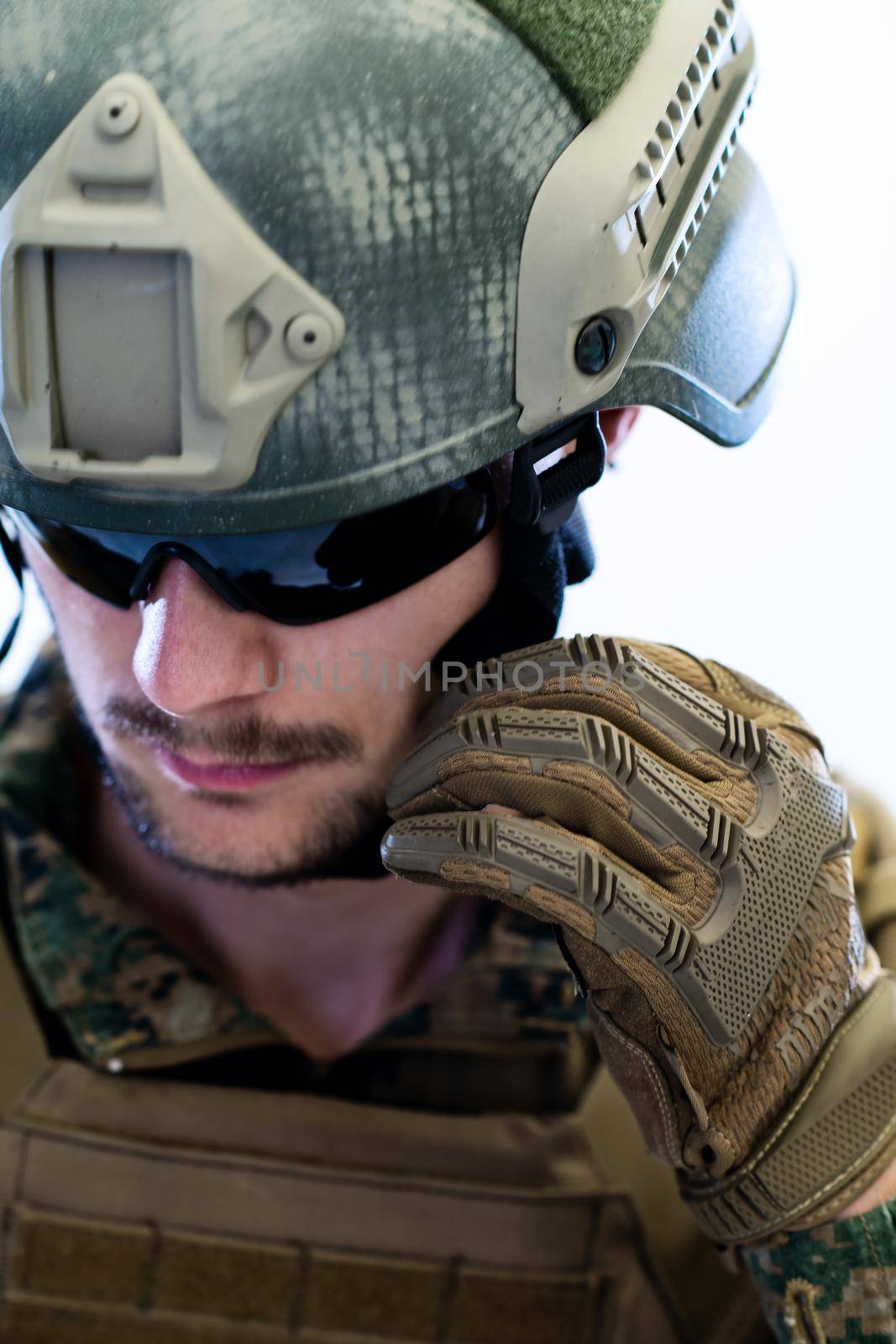 american  marine corps special operations soldier preparing tactical and commpunication gear for action battle closeup studio portrait isolated on white background