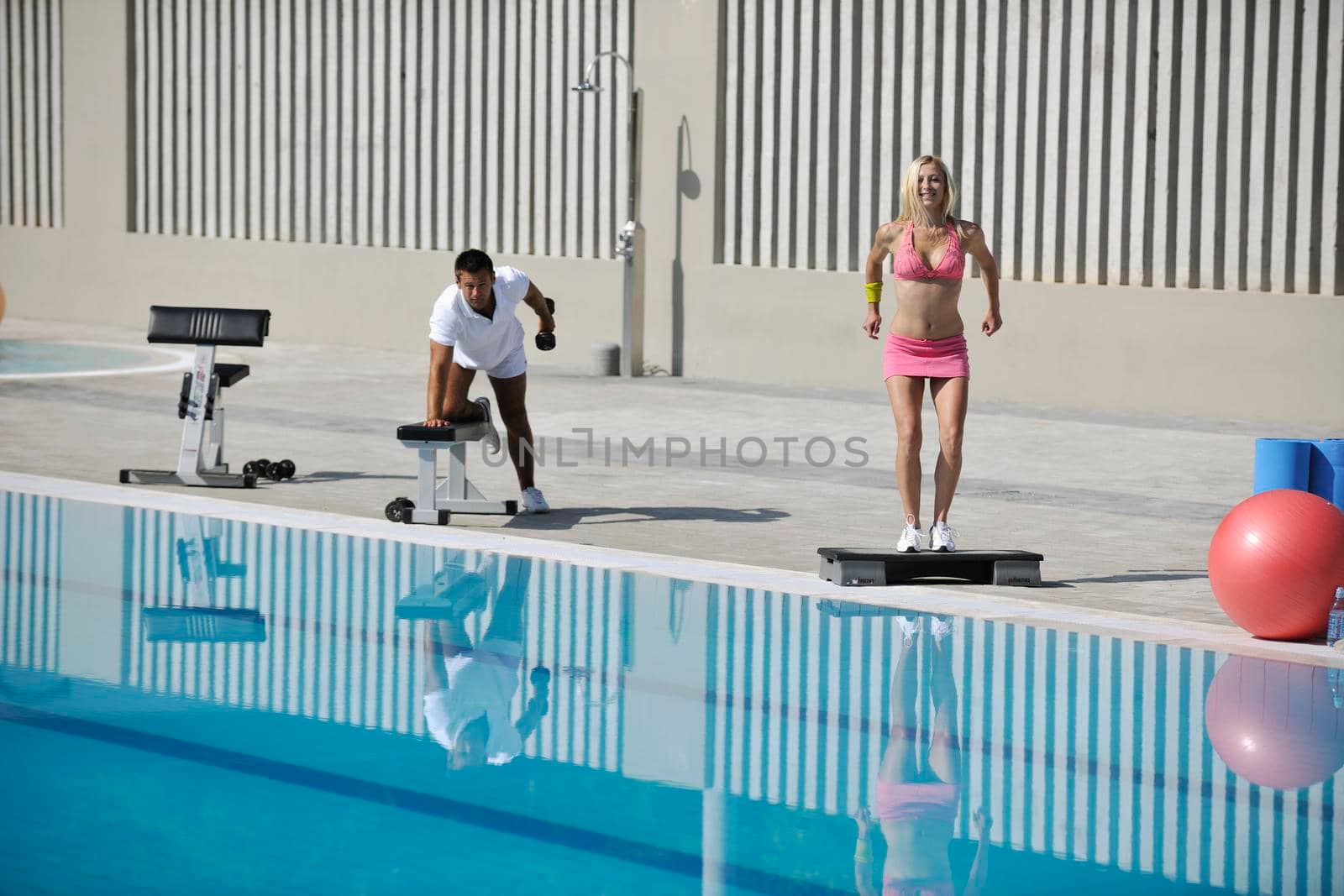 young couple exercise aerobic and fitness at early morning at swimming pool