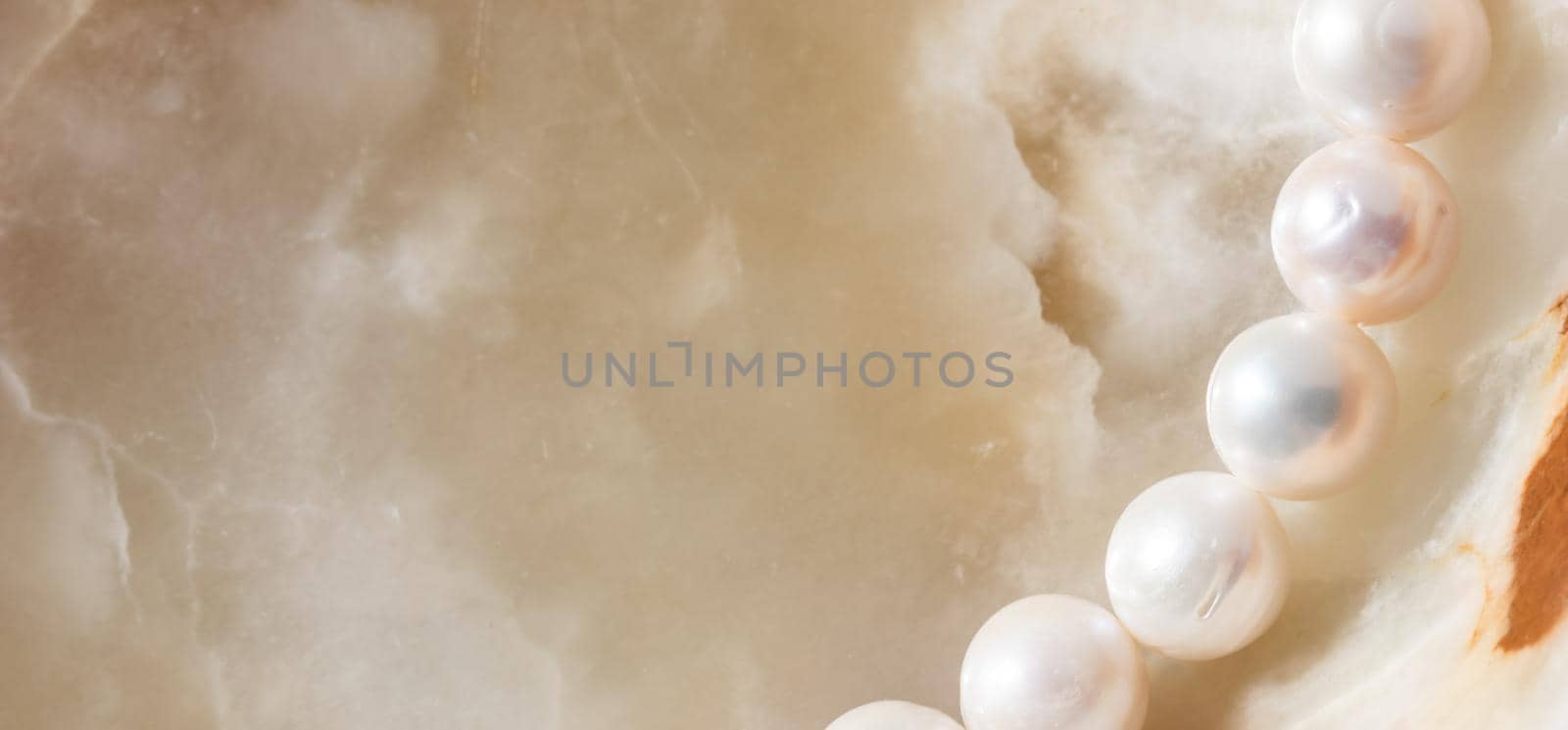 Nature white string of pearls on marble background in soft focus by Olayola