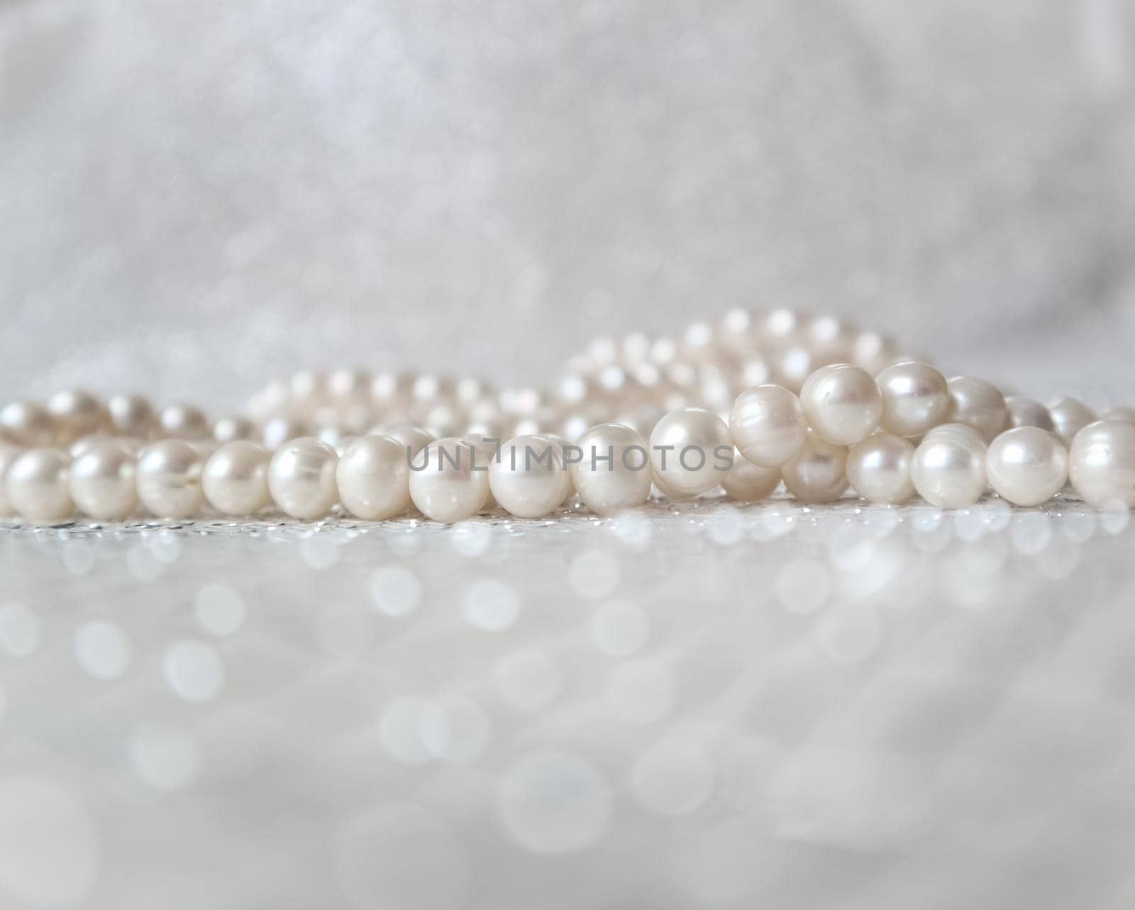 Nature white pearl beads on sparkling background