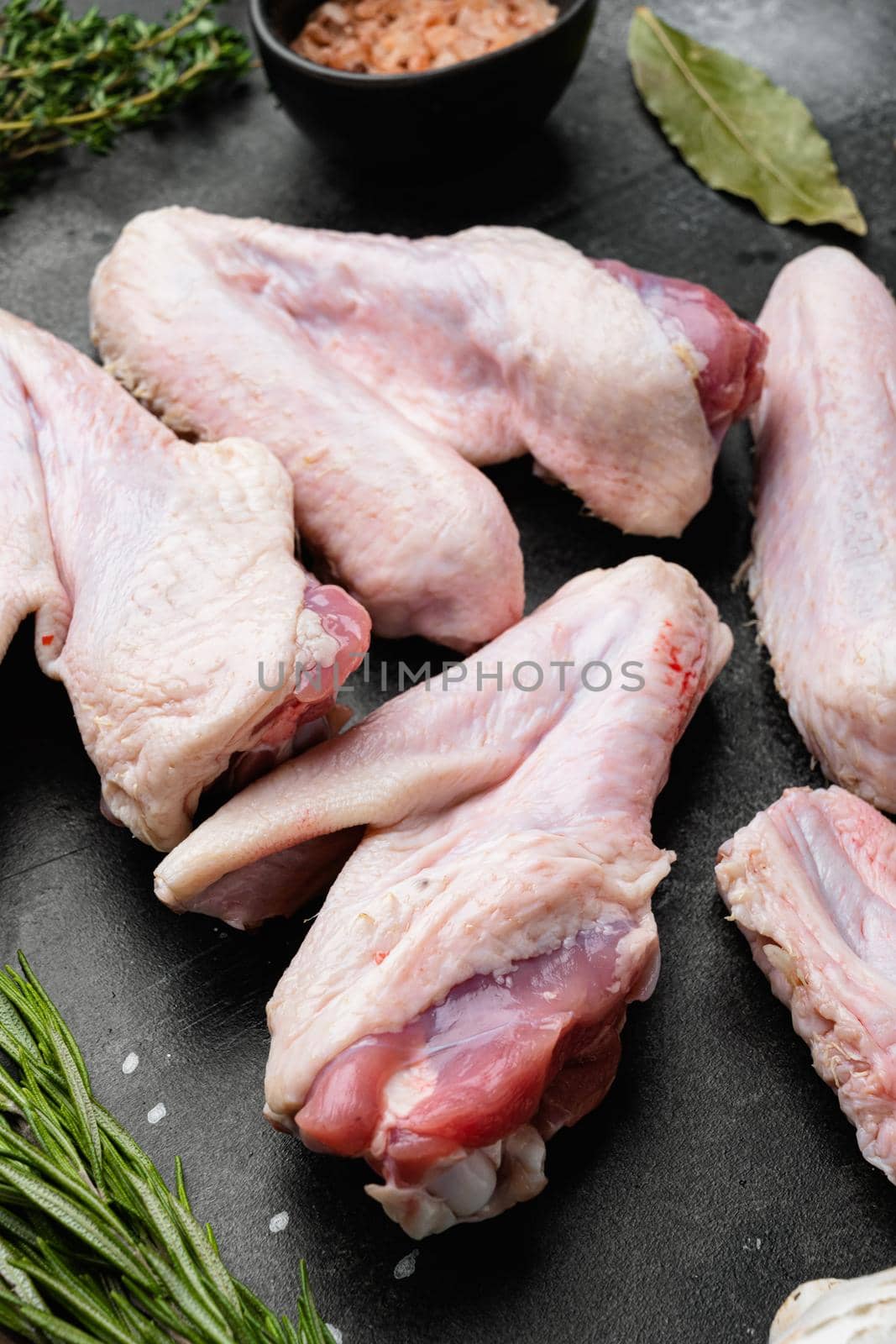 Whole raw free range chicken set, on black dark stone table background