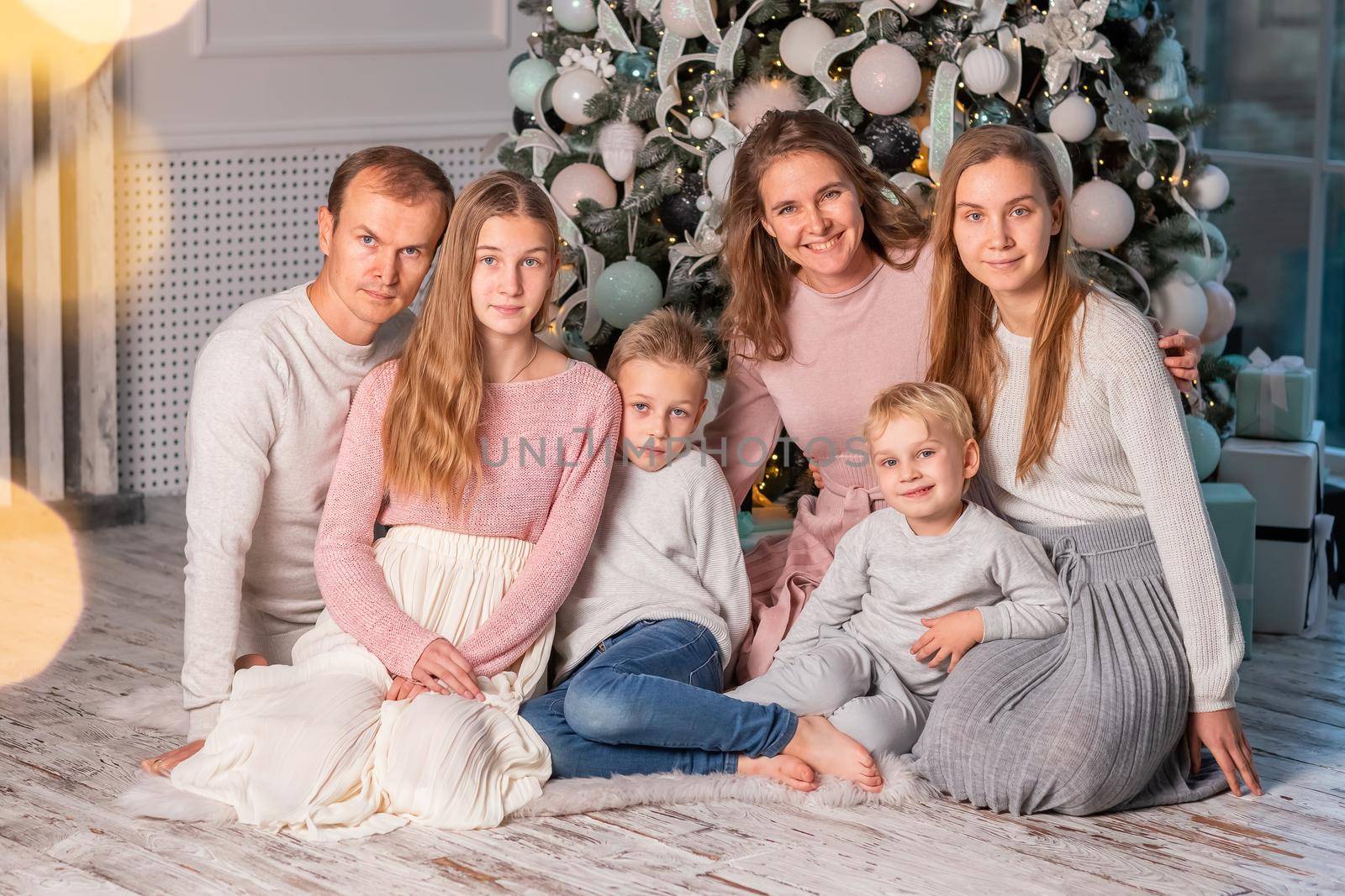 Big happy family with many kids opening presents under the Christmas tree on Christmas eve by Len44ik