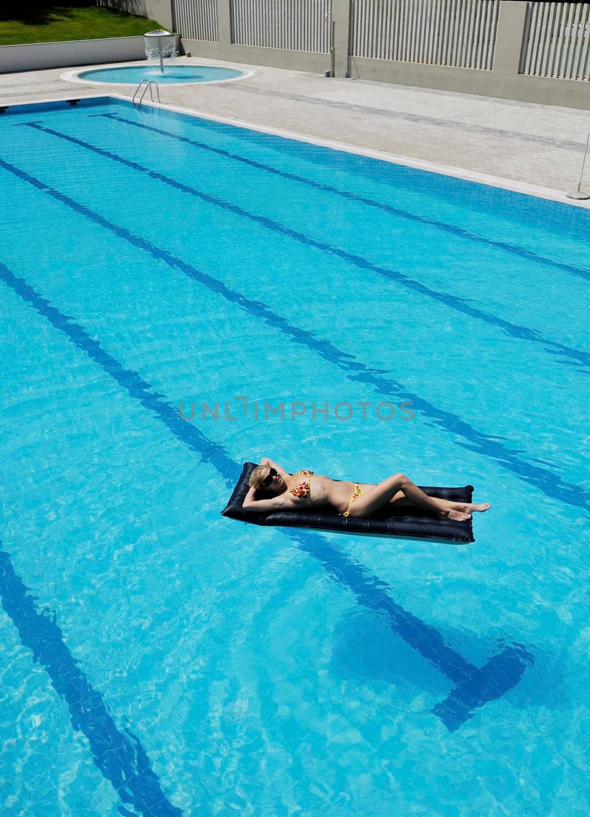 beautiful young woman relax and have fun at swimming pool